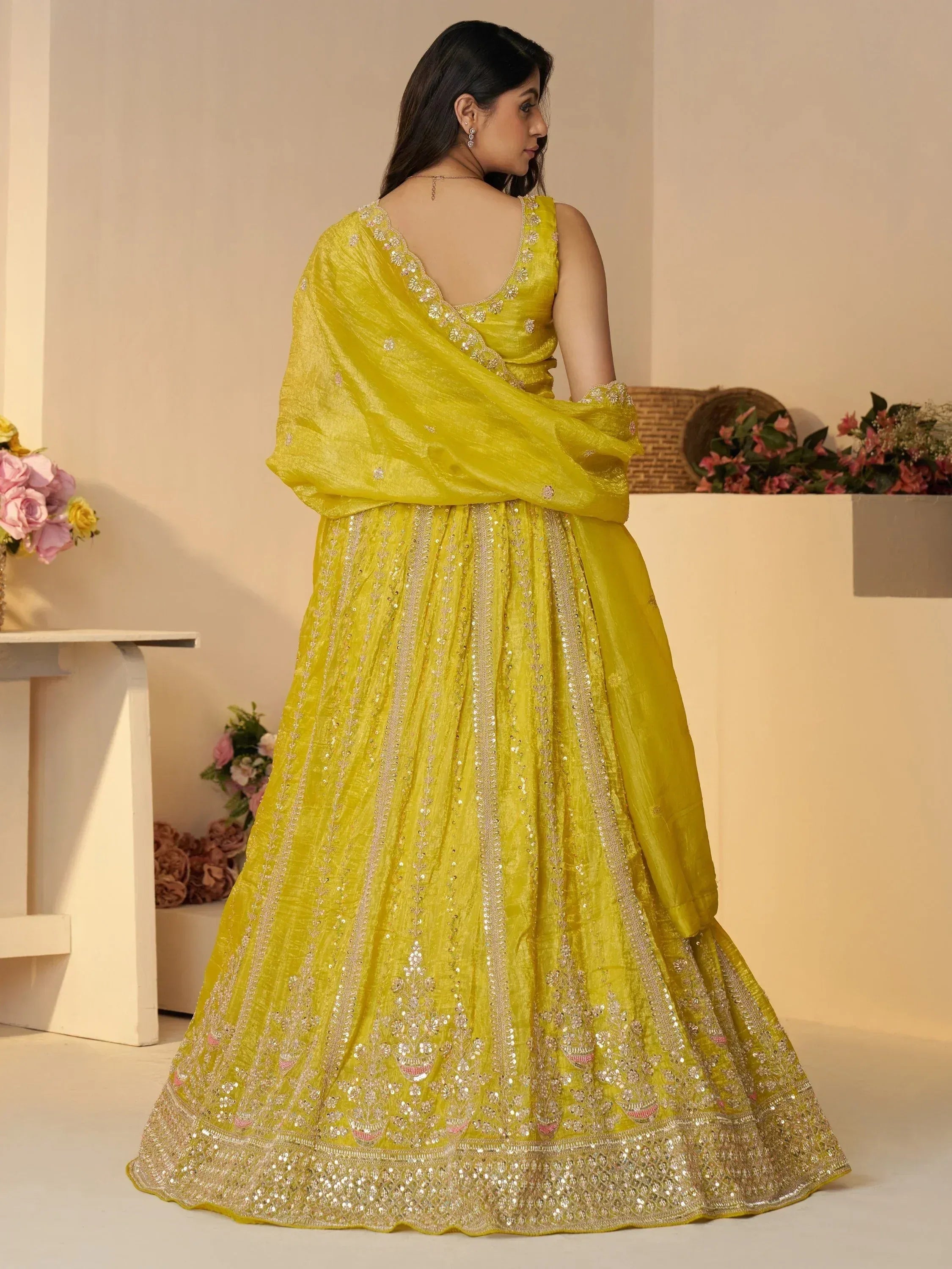 Yellow designer lehenga choli with intricate embroidery and sequin work, perfect for Indian ethnic occasions