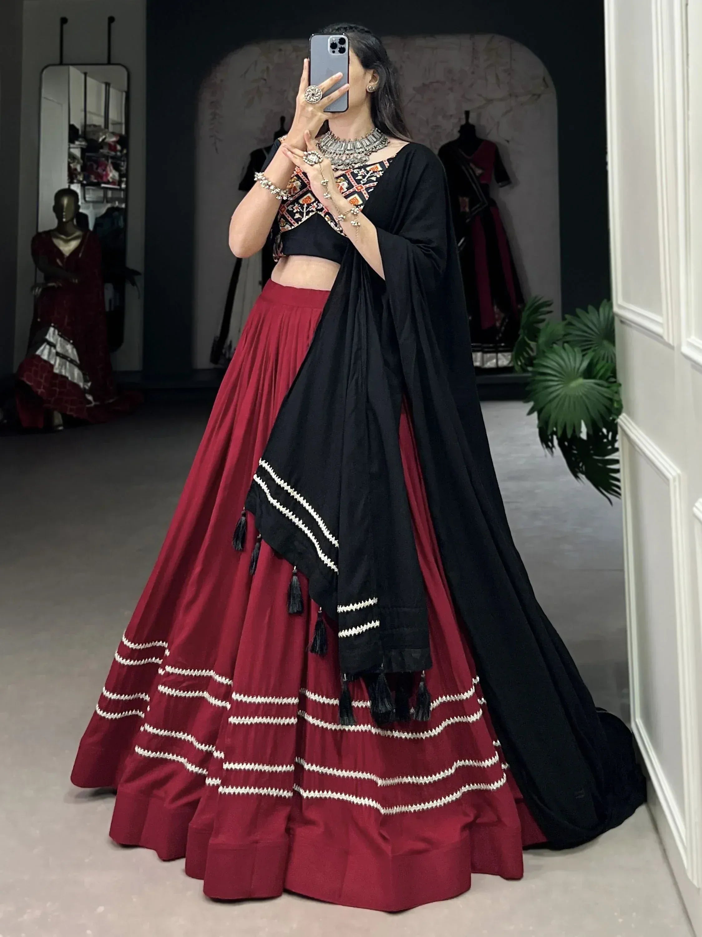 Woman in maroon lehenga with black dupatta and embroidered blouse, ethnic Indian wear