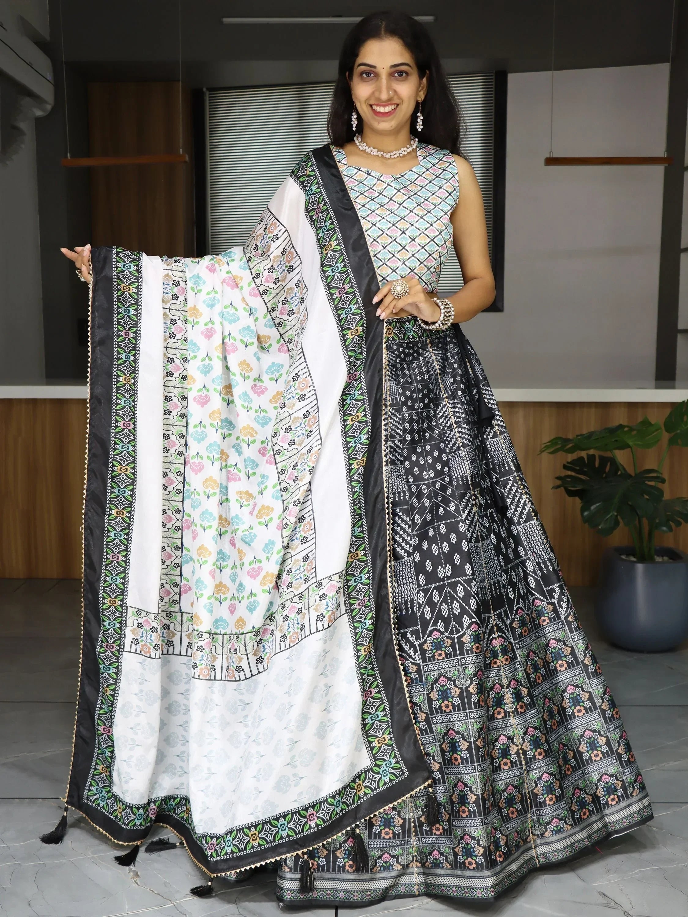 Woman in black and white printed lehenga choli with floral dupatta, Indian ethnic wear