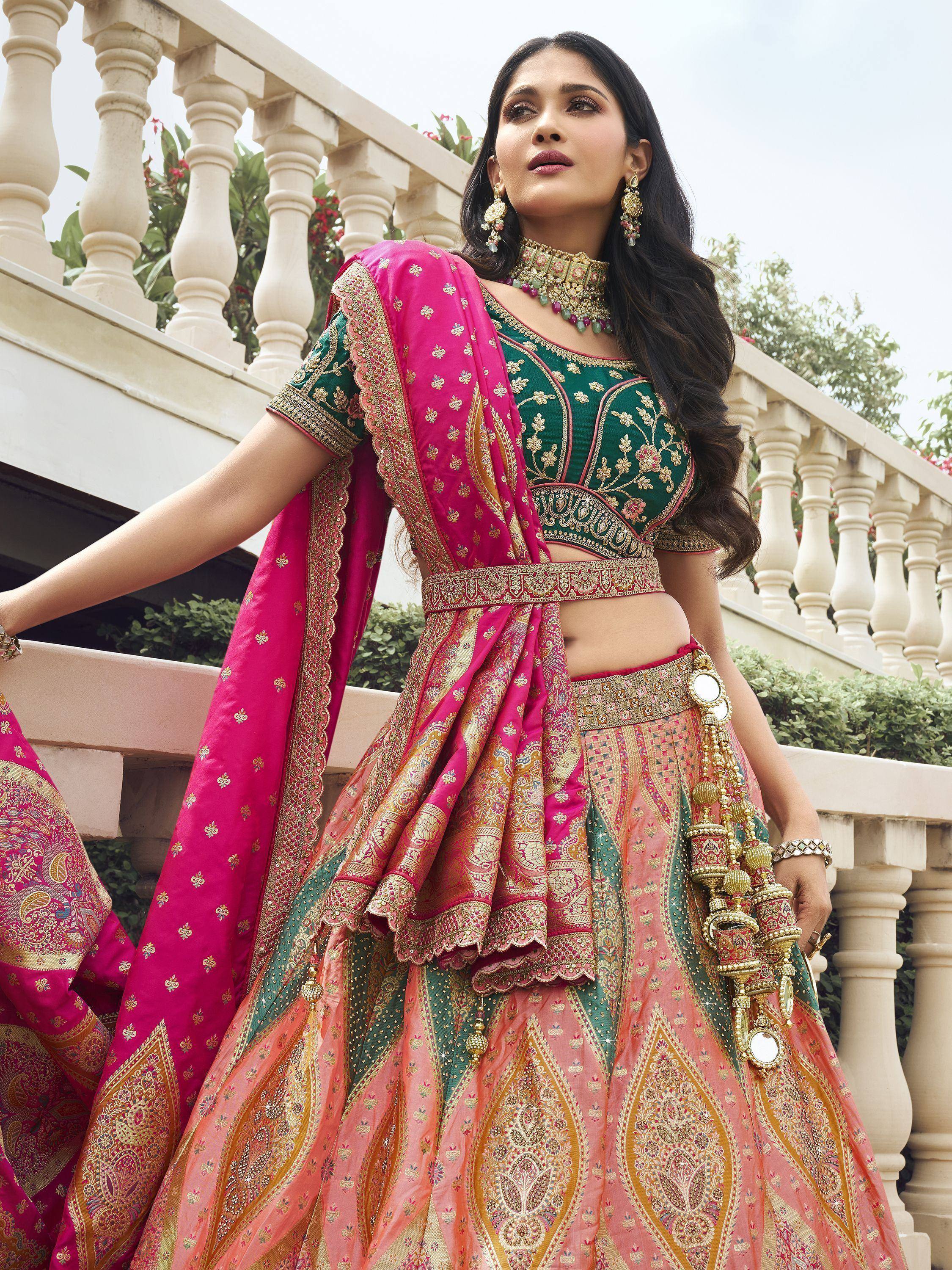 Elegant green and pink embroidered lehenga choli with gold detailing, perfect for Indian weddings and festive occasions.