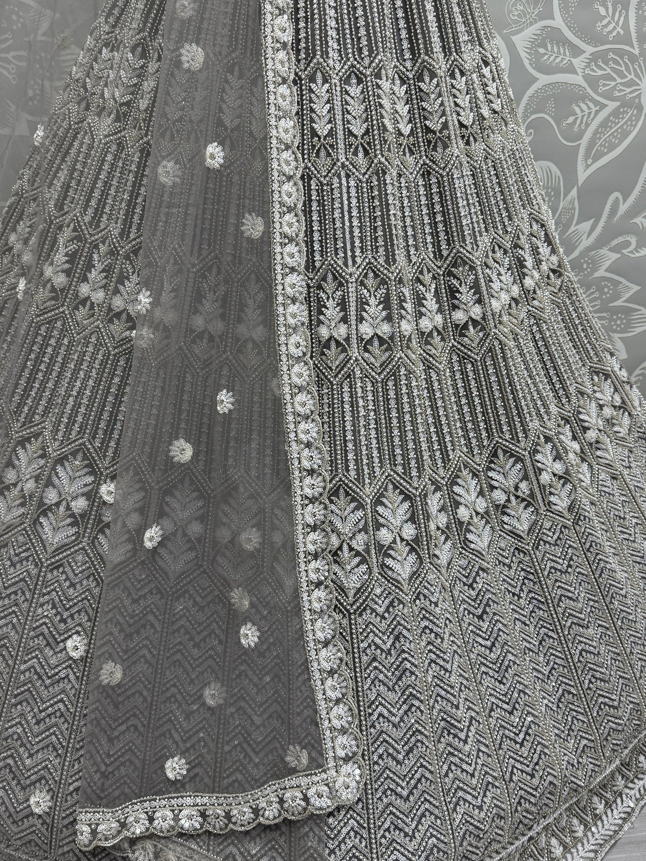 Grey designer lehenga with intricate silver embroidery and sequin work, perfect for Indian ethnic wear.
