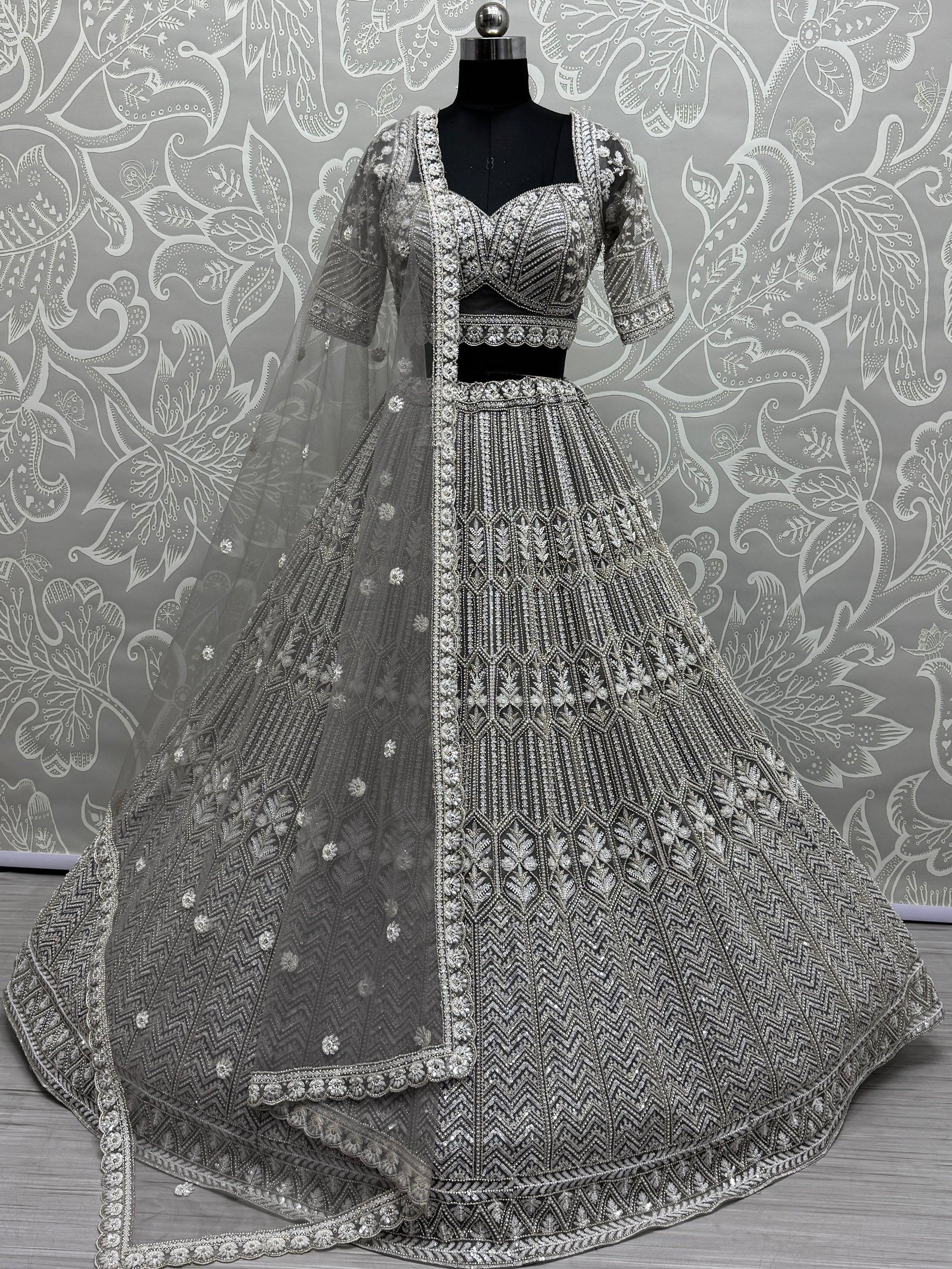 Grey designer lehenga choli with heavy silver embroidery and net dupatta, perfect for weddings and parties.