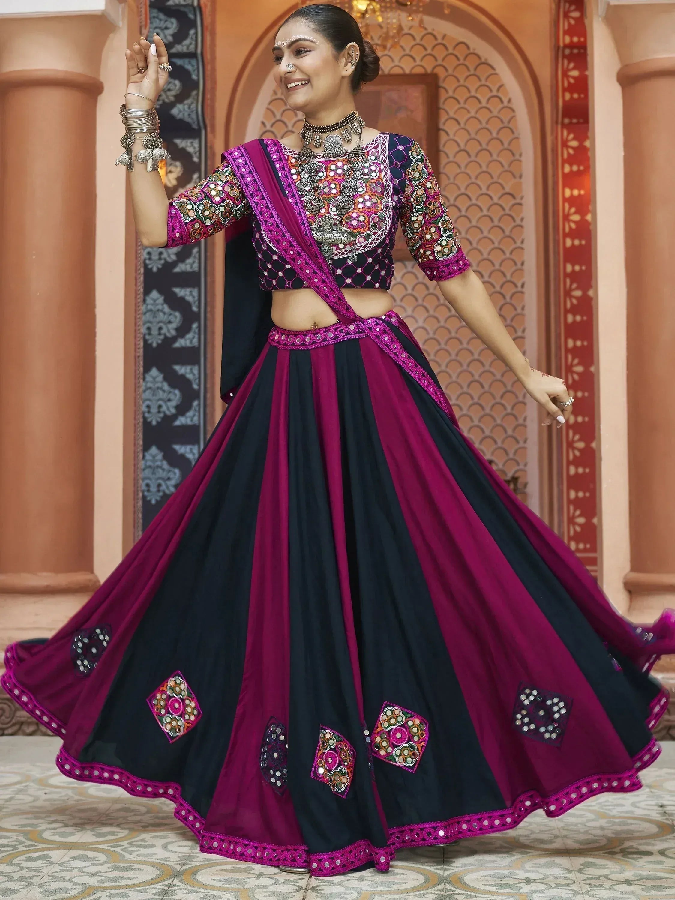 Black and magenta mirror work lehenga choli with embroidered blouse and dupatta, perfect for Indian ethnic wear