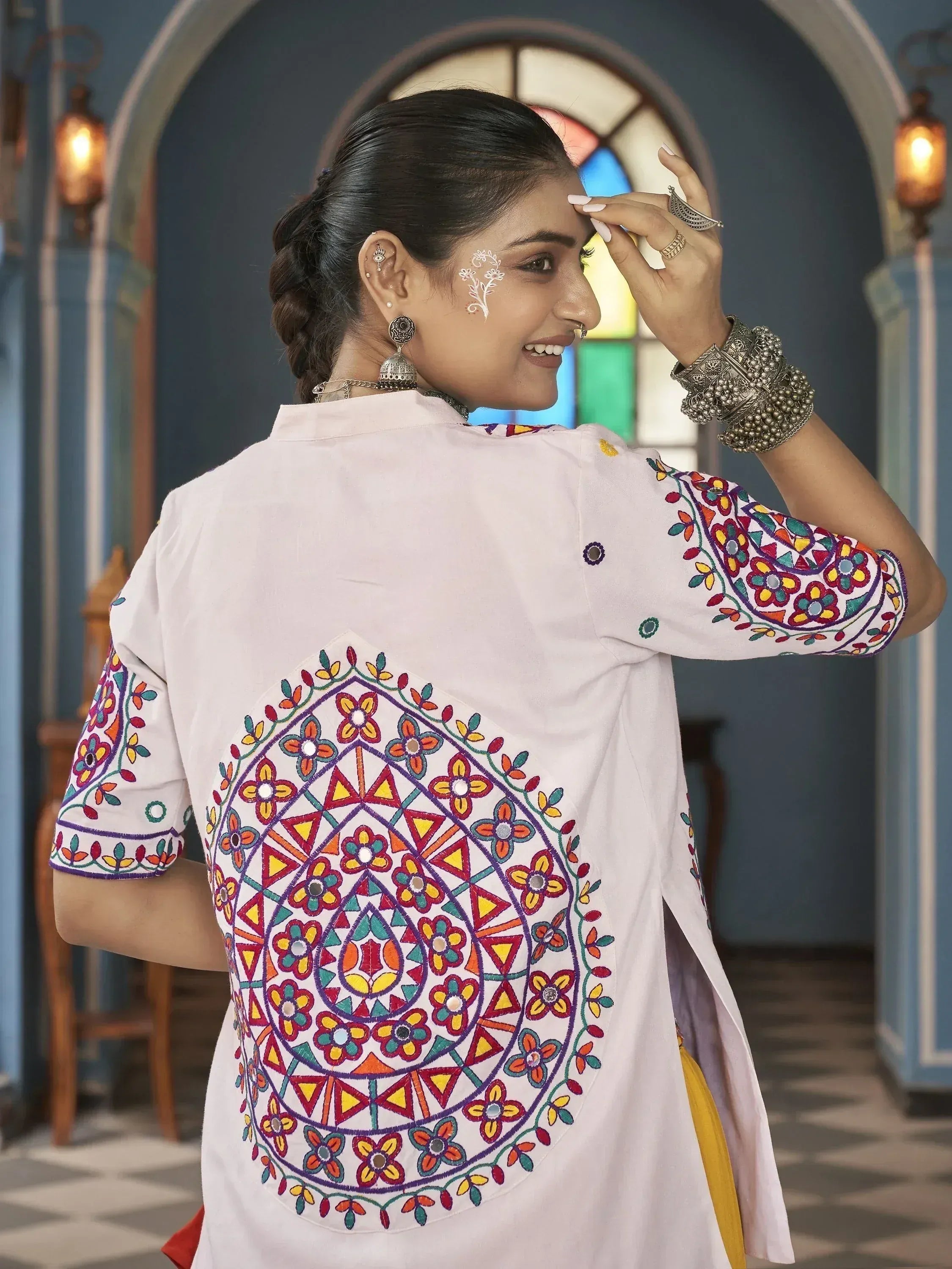 White embroidered kurta with colorful floral patterns, perfect for ethnic wear
