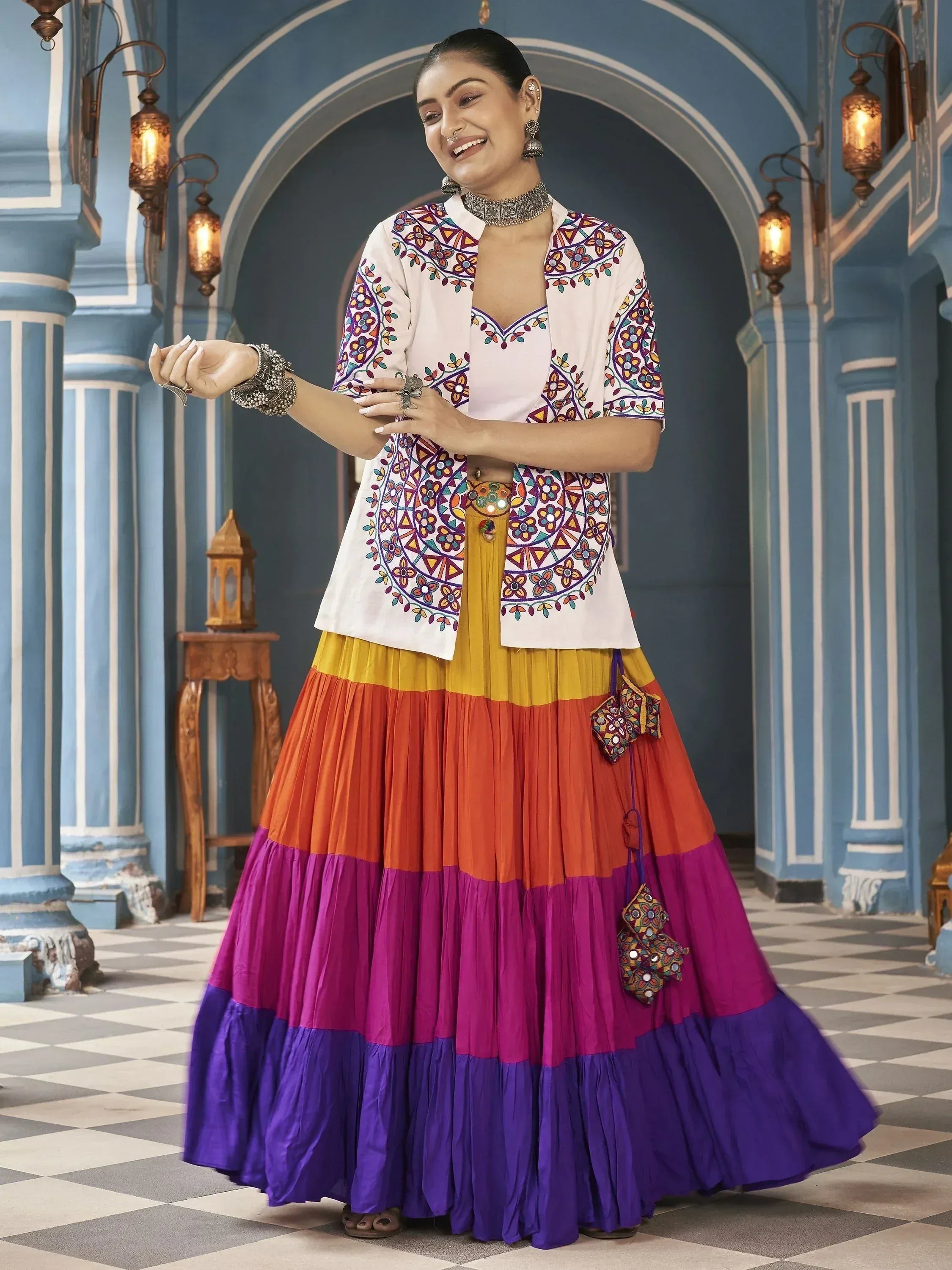 Colorful ethnic lehenga with embroidered jacket and layered skirt, perfect for festive occasions.