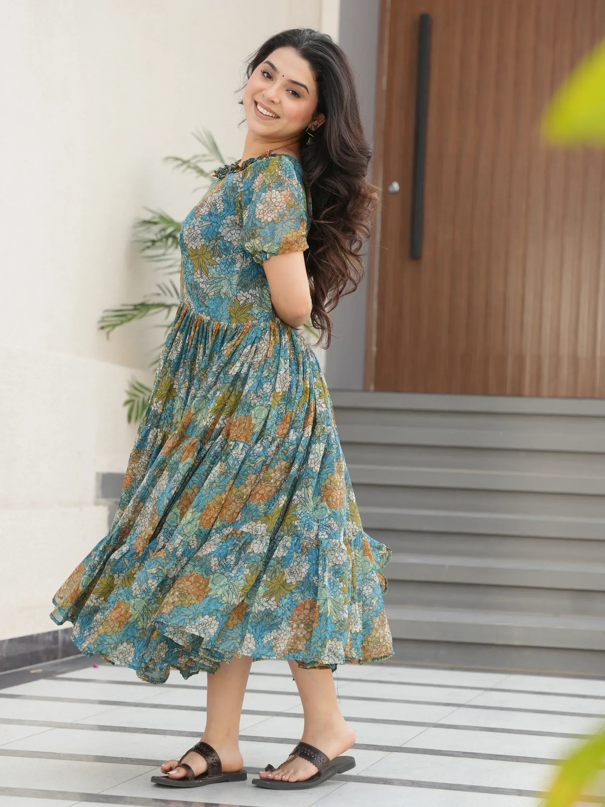 Woman in blue floral ethnic gown with puff sleeves, perfect for casual Indian wear