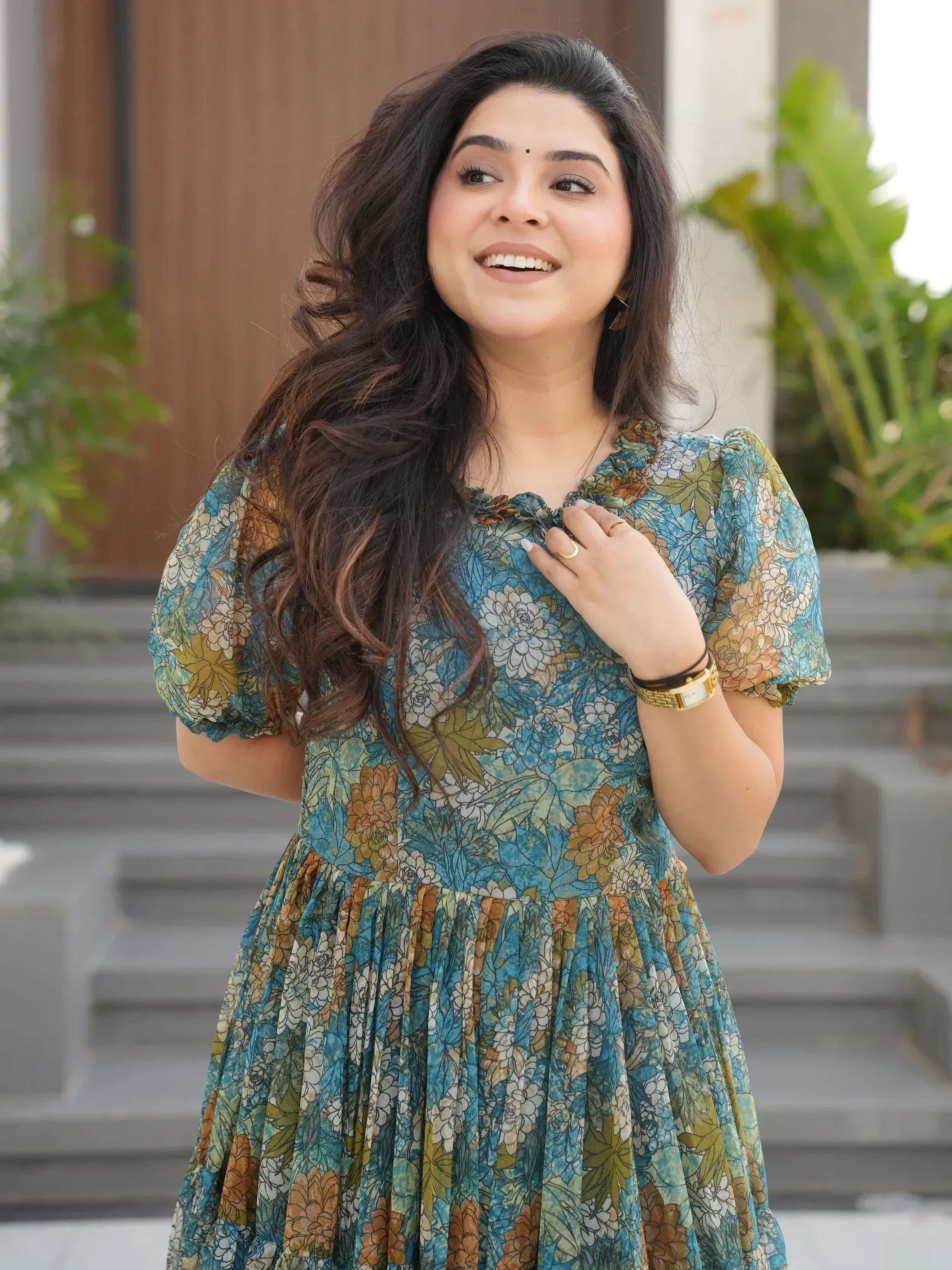 Woman in floral ethnic gown with puff sleeves, perfect for Indian occasions and festive wear