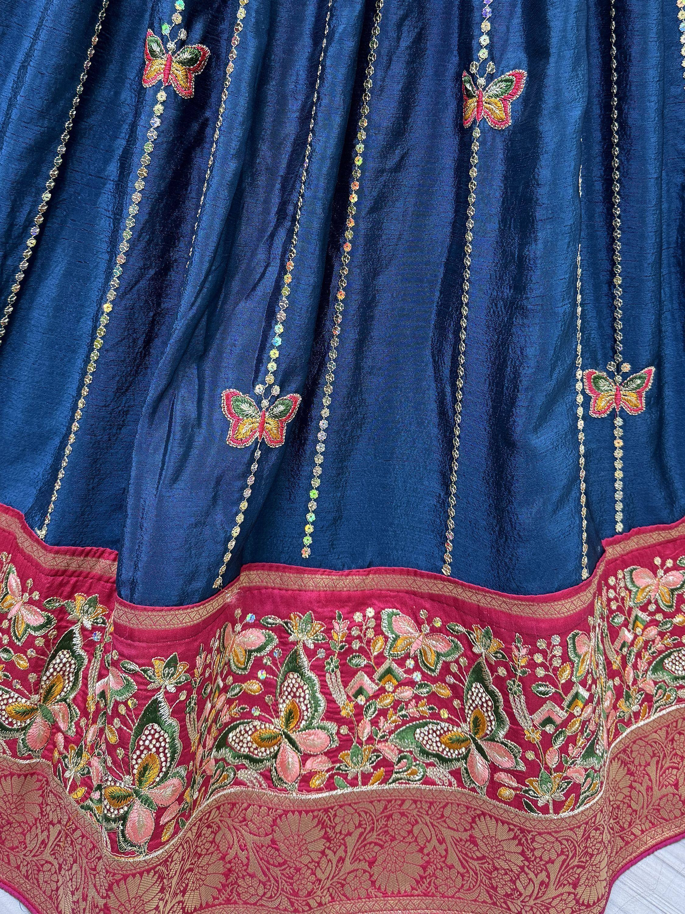 Blue velvet lehenga with butterfly embroidery and crystal chains, pink floral border