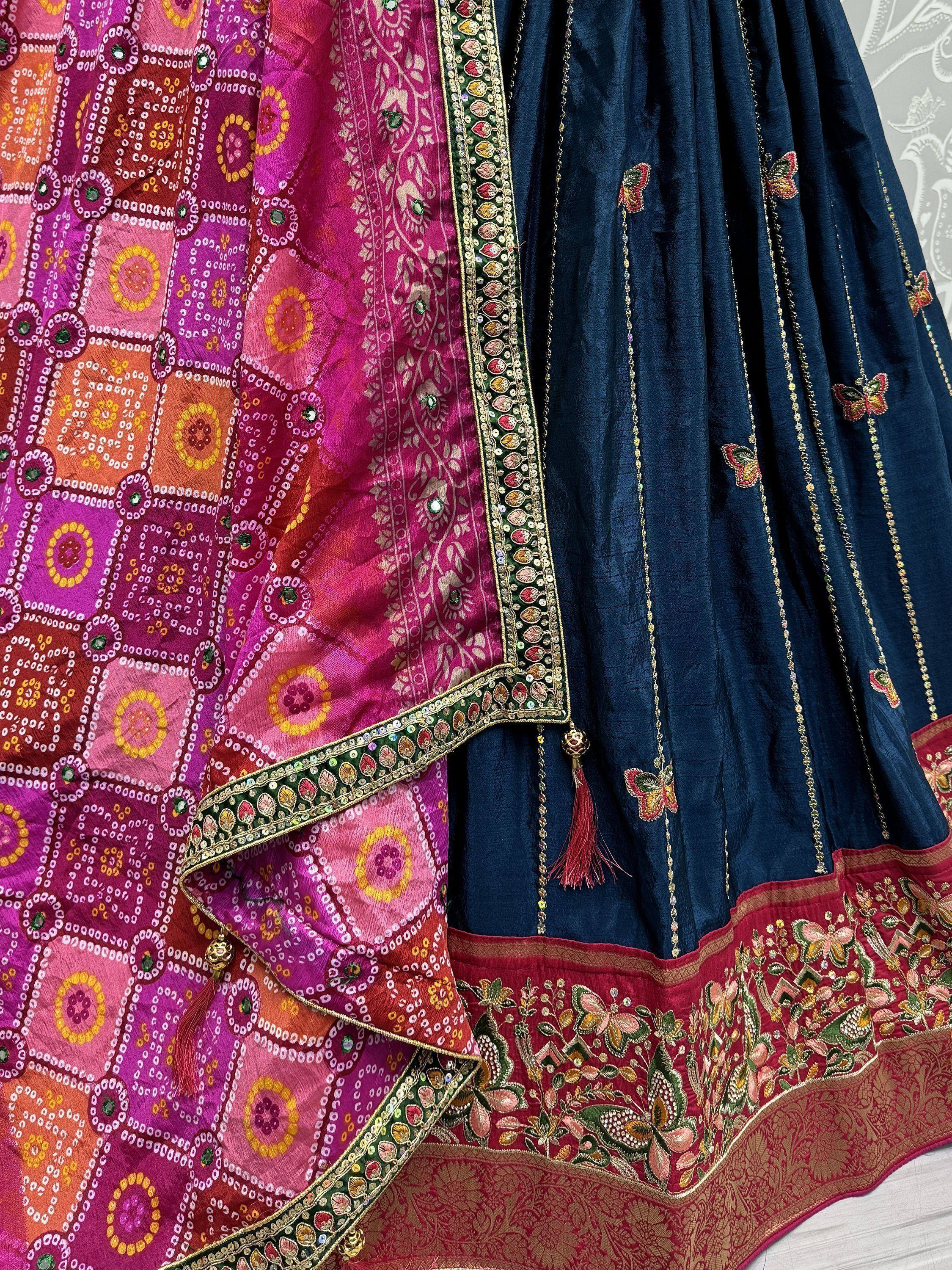 Designer lehenga choli with embroidered navy skirt, colorful dupatta, and butterfly motifs for Indian ethnic wear