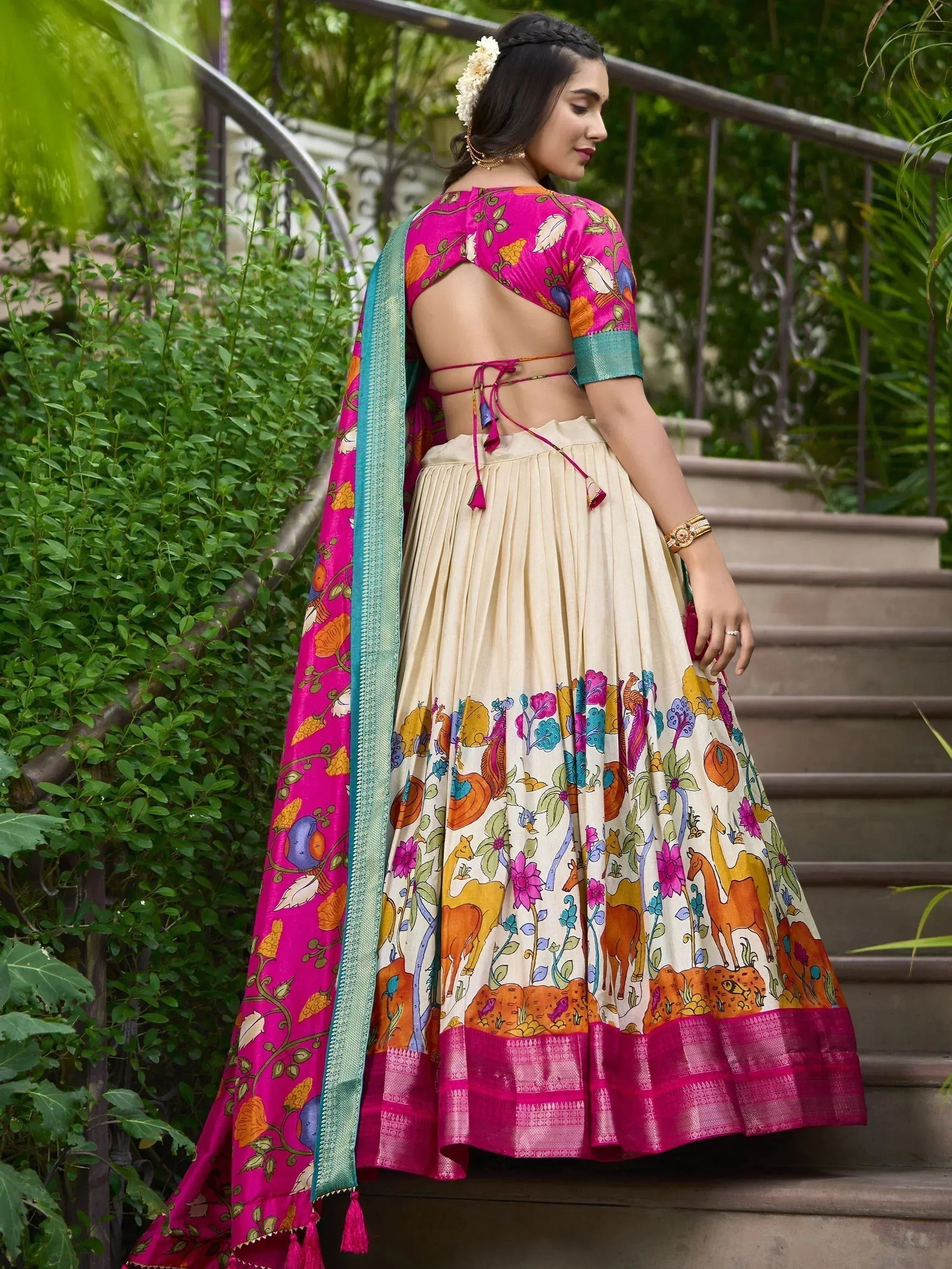 Vibrant pink and cream printed lehenga choli with floral and animal motifs, perfect for Indian ethnic wear.