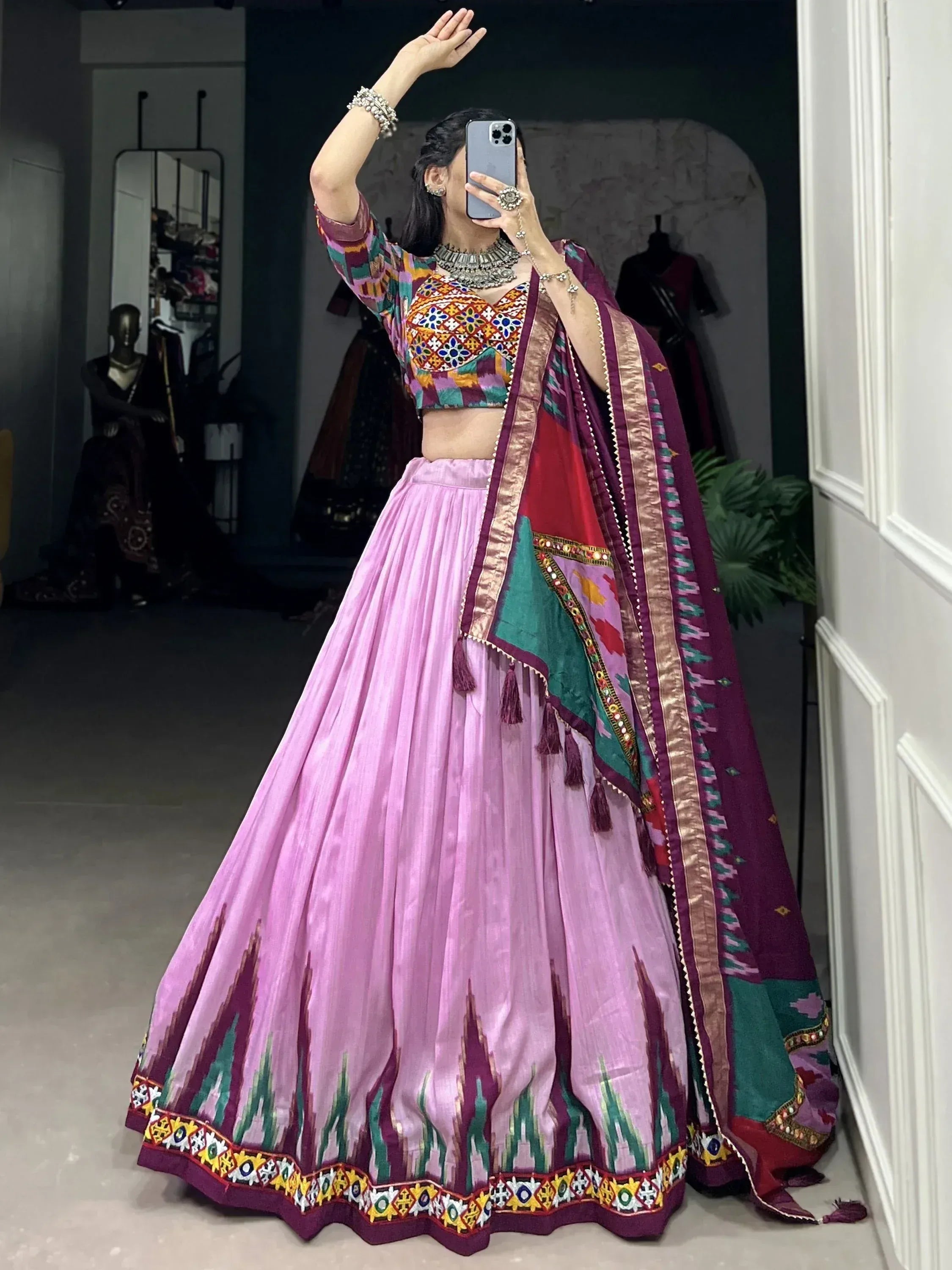 Vibrant pink lehenga choli with colorful embroidery and dupatta, perfect for Indian ethnic wear.