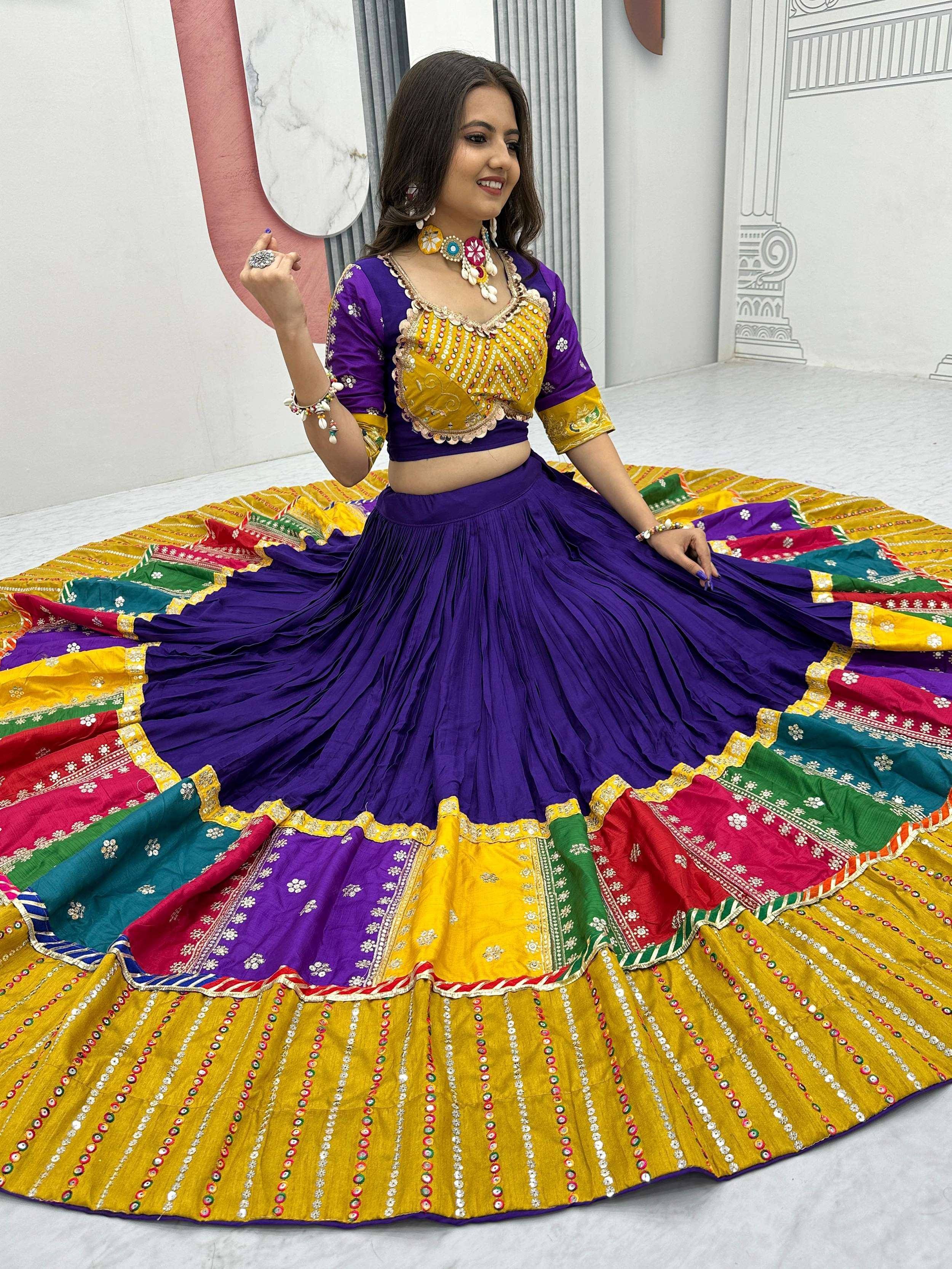 Vibrant purple and yellow designer lehenga choli with mirror work, perfect for Indian ethnic wear and festive occasions.