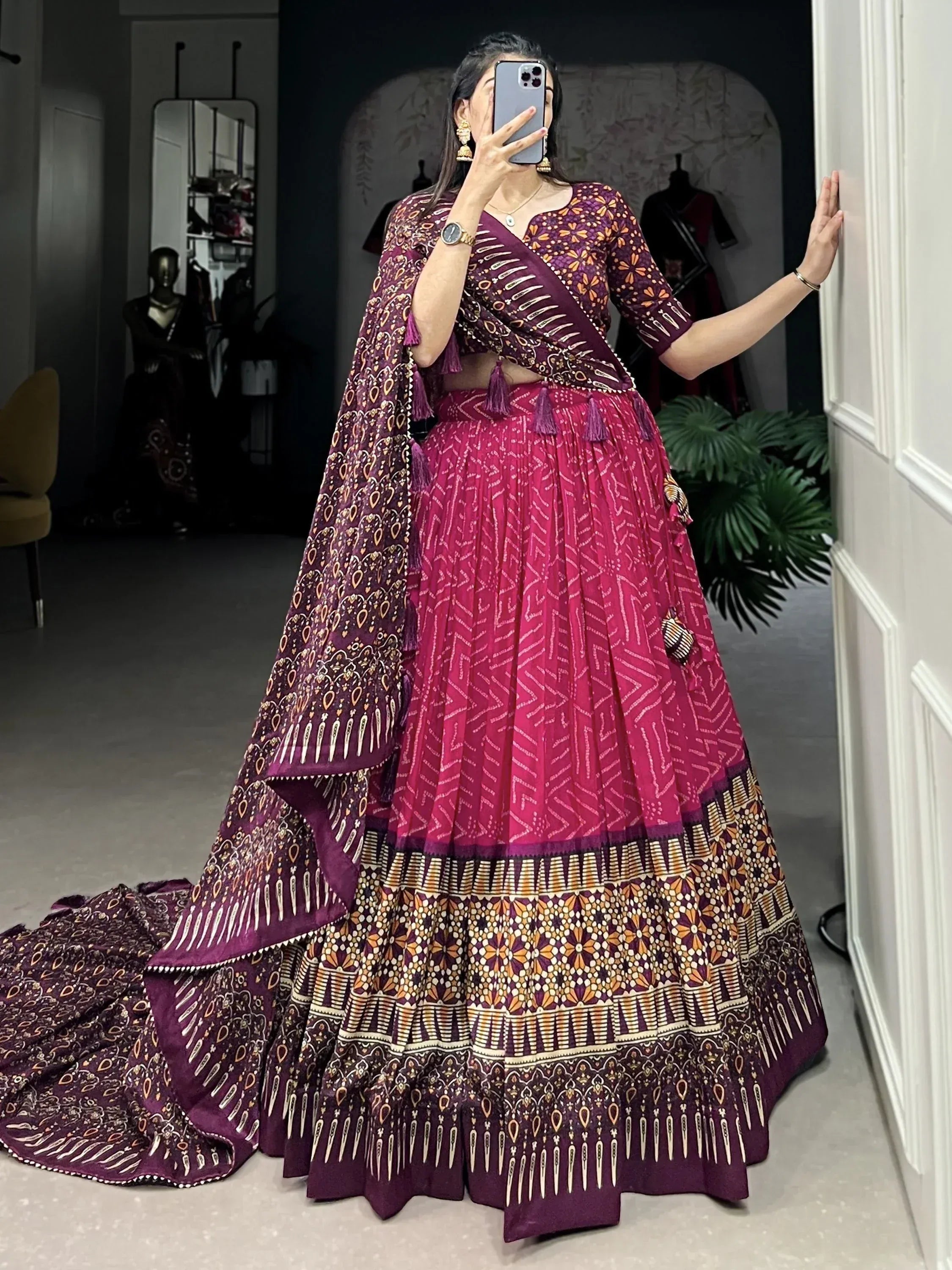 Purple and pink printed lehenga choli with tassels, perfect for Indian ethnic wear and festive occasions.