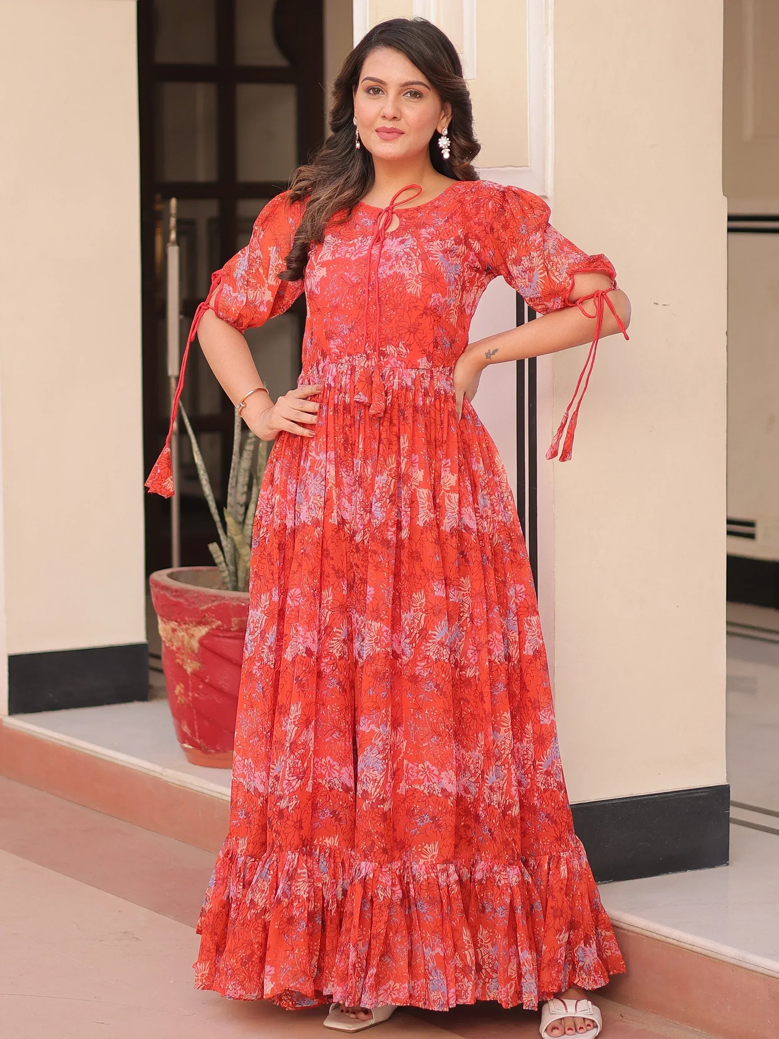 Red floral ethnic gown with puff sleeves and tie-up details, perfect for Indian occasions