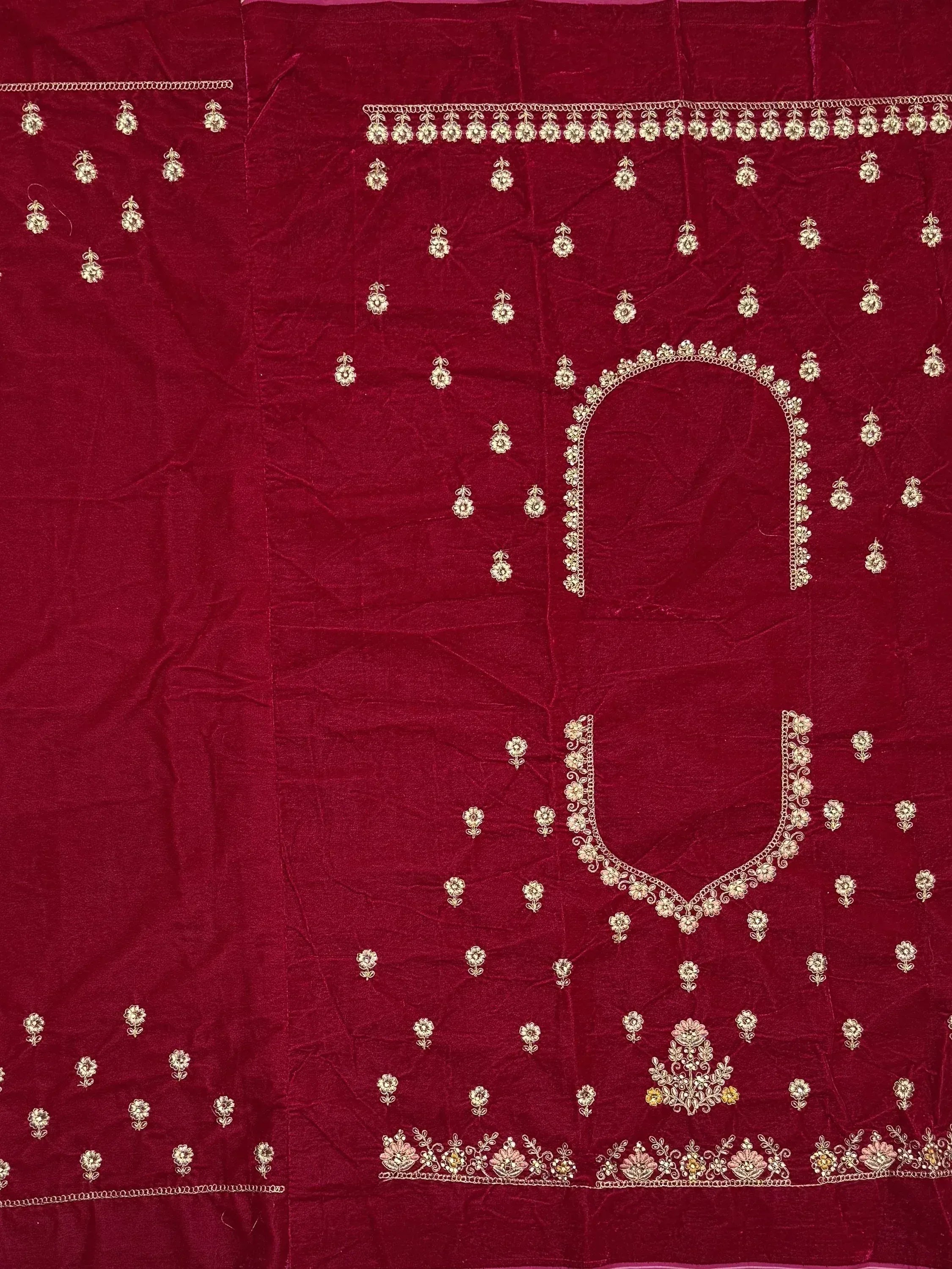 Rich maroon velvet ethnic wear with gold floral embroidery and detailed neckline design