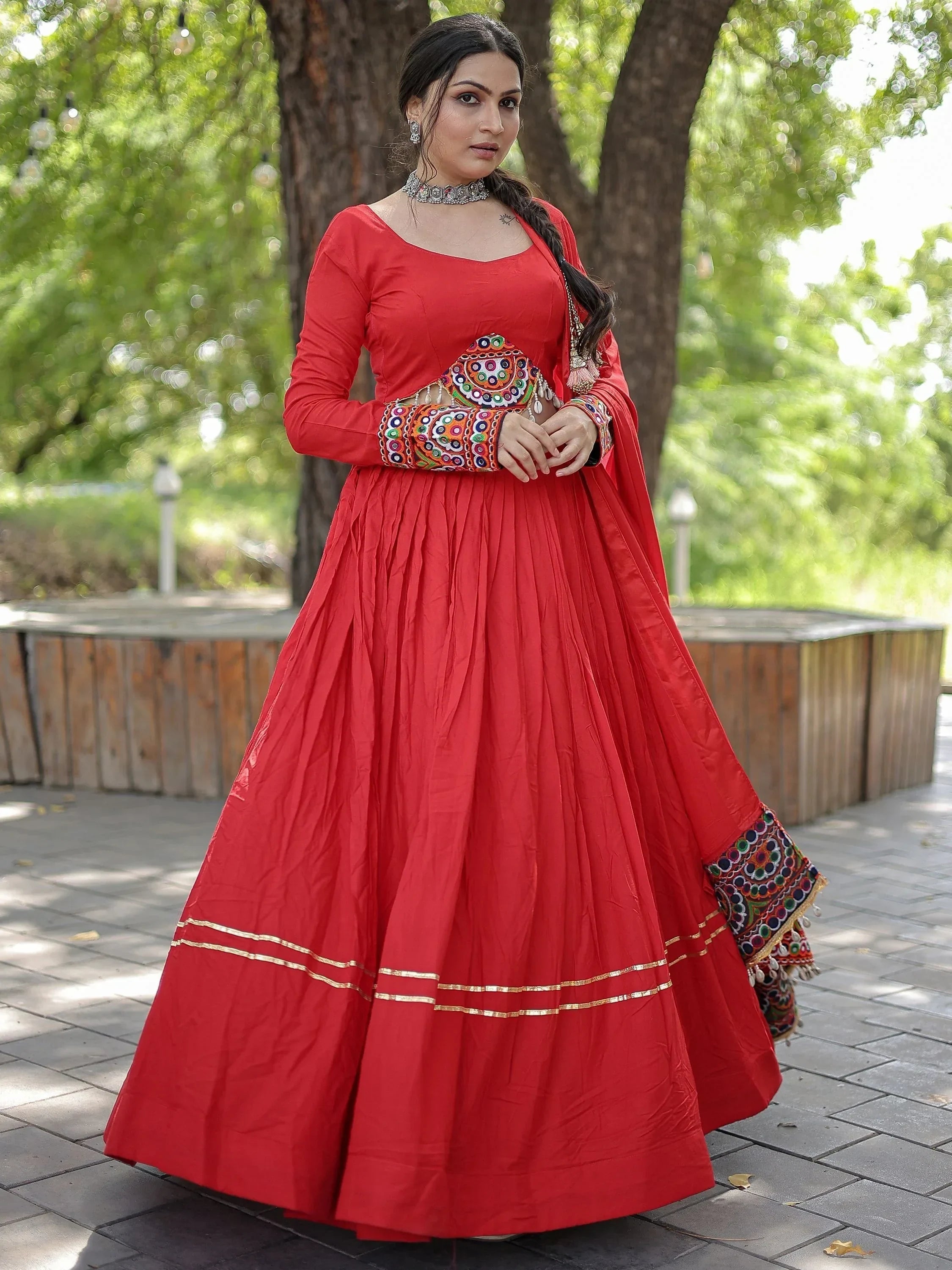Red ethnic anarkali with mirror work, perfect for Indian weddings or festive occasions