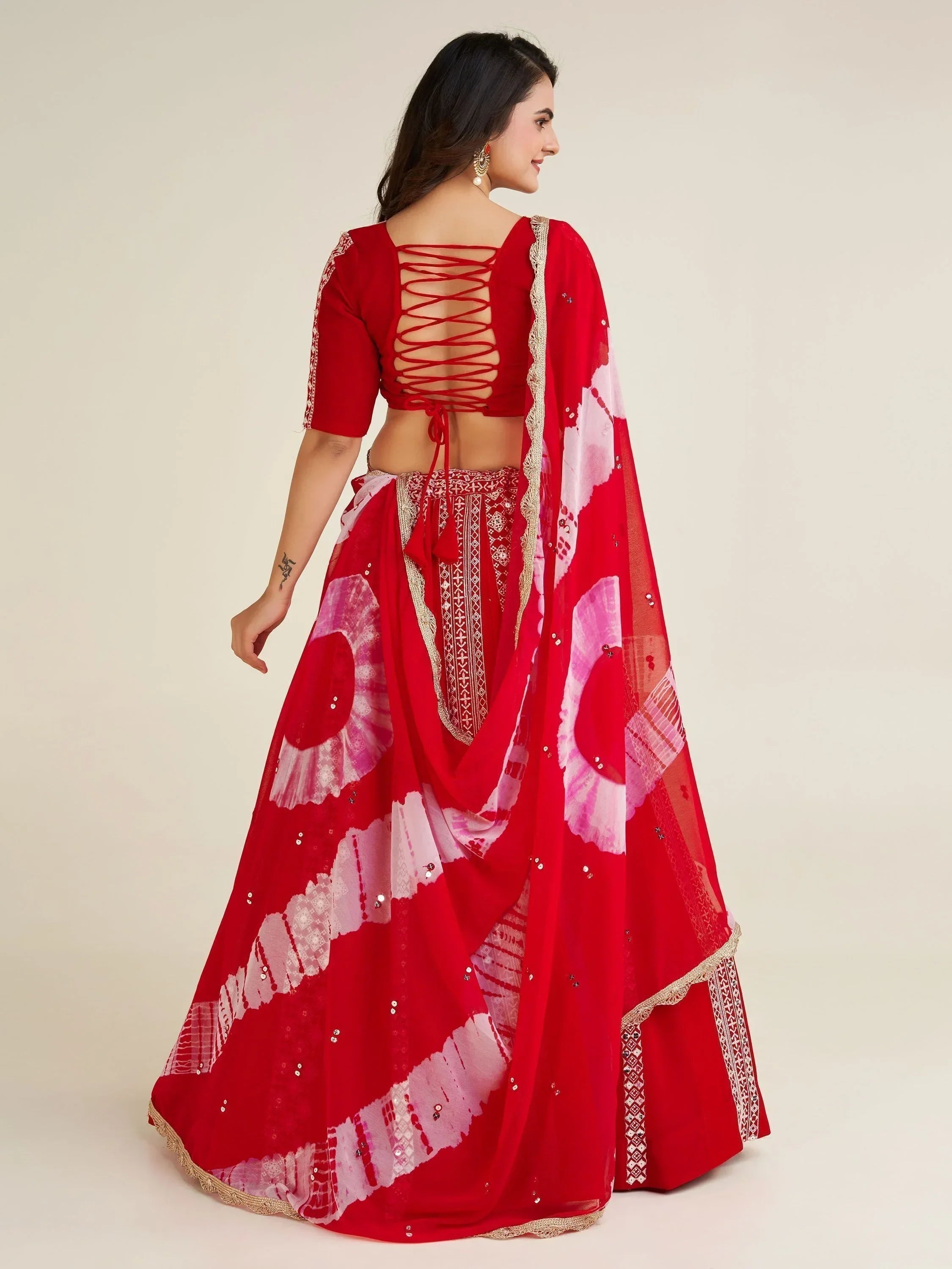 Red lehenga choli with lace-up back and floral dupatta, perfect for Indian ethnic wear