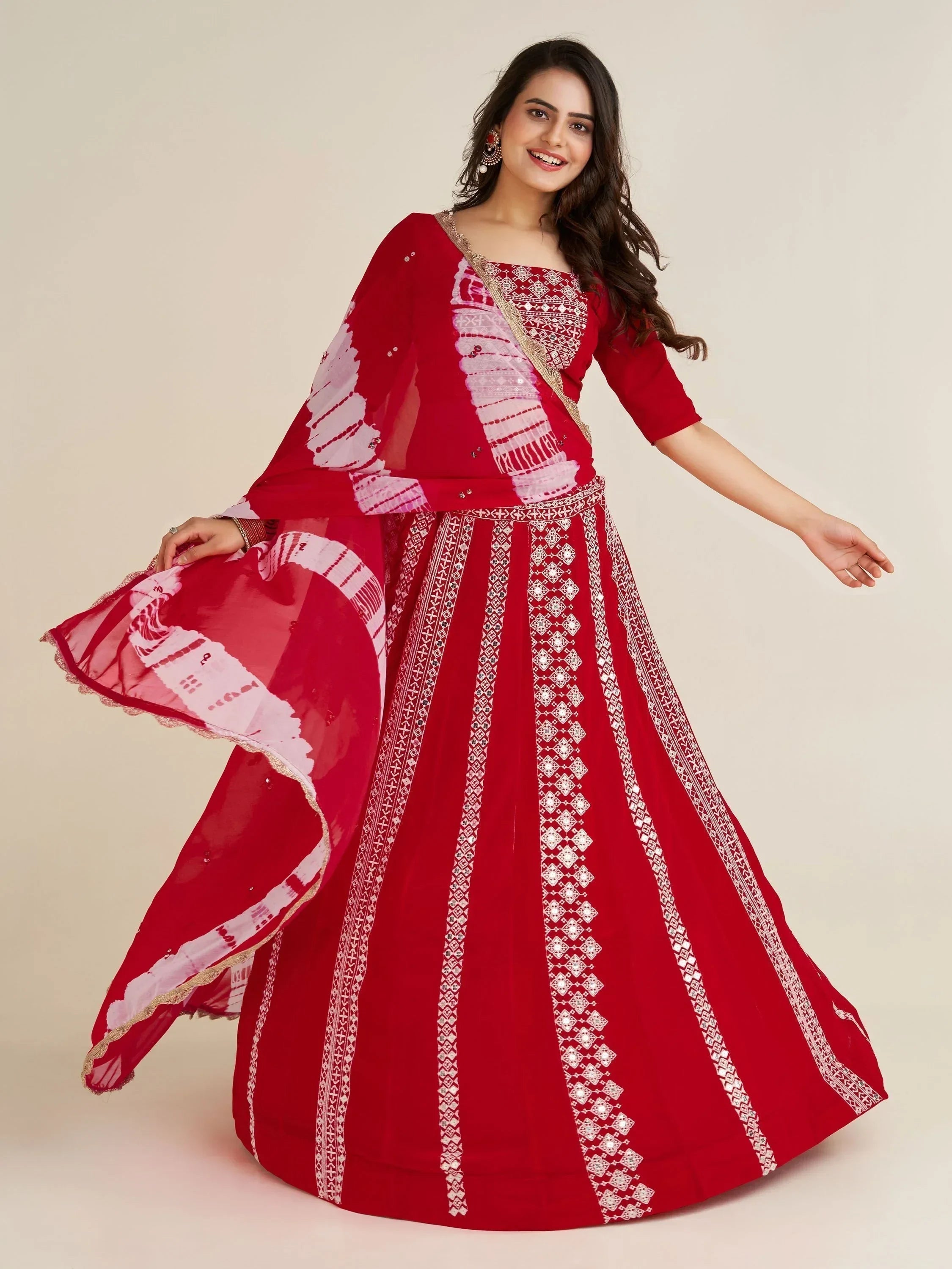 Red ethnic gown with white embroidery and flowing dupatta for festive occasions