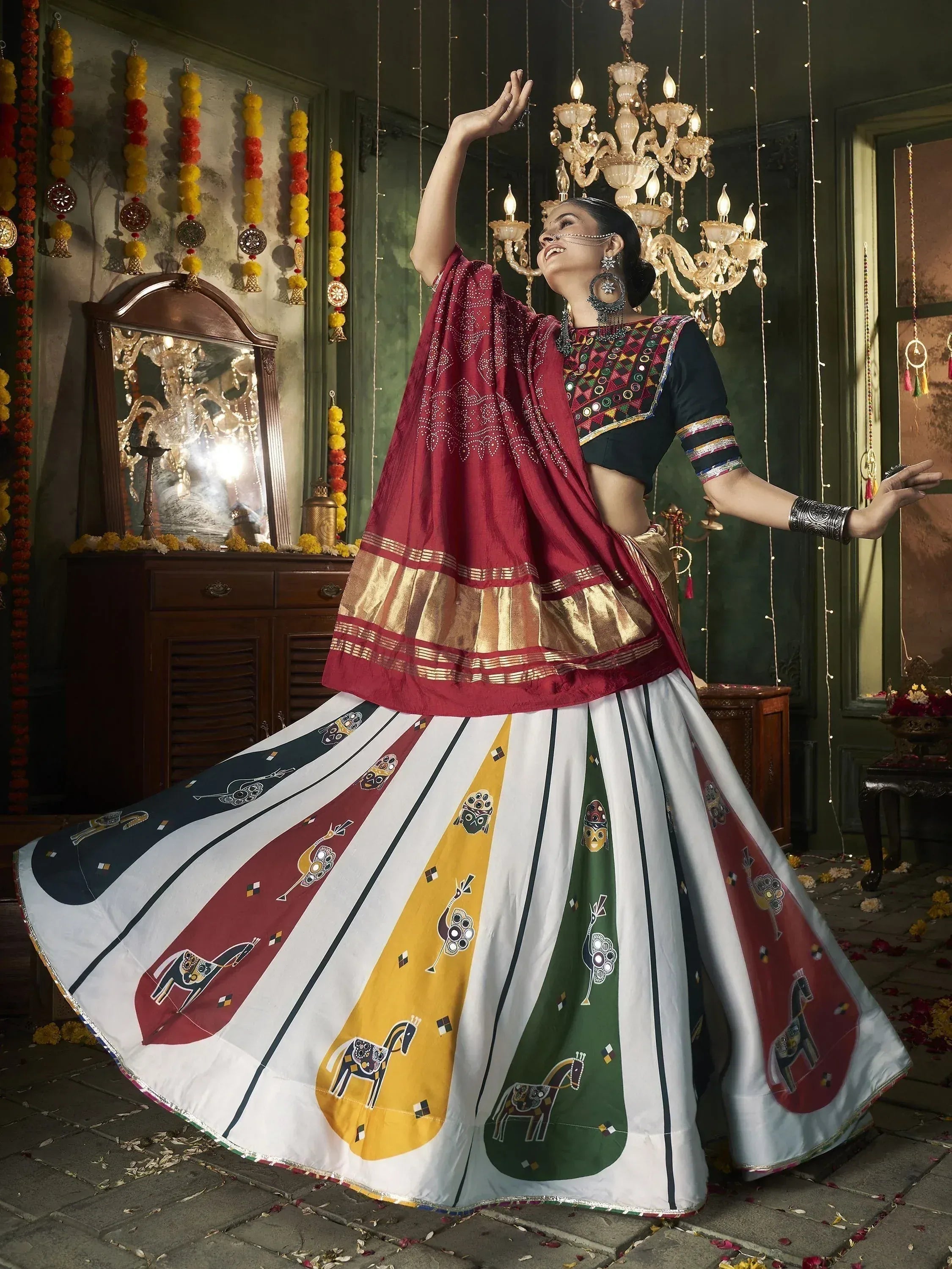 Woman in colorful ethnic lehenga choli with horse print, dancing under chandelier