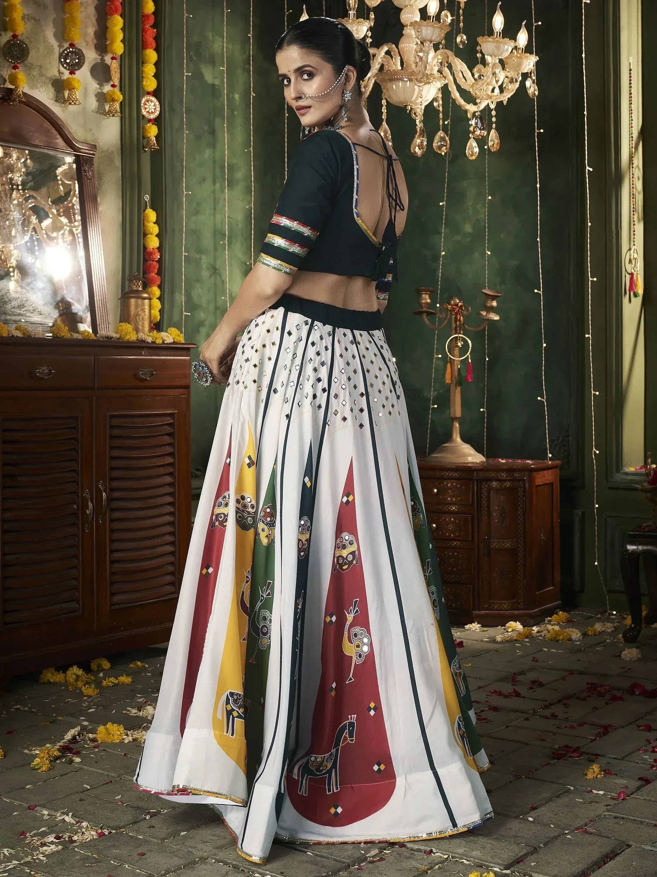 Woman in designer Indian lehenga choli with mirror work and tribal print, ethnic wear for festive occasions