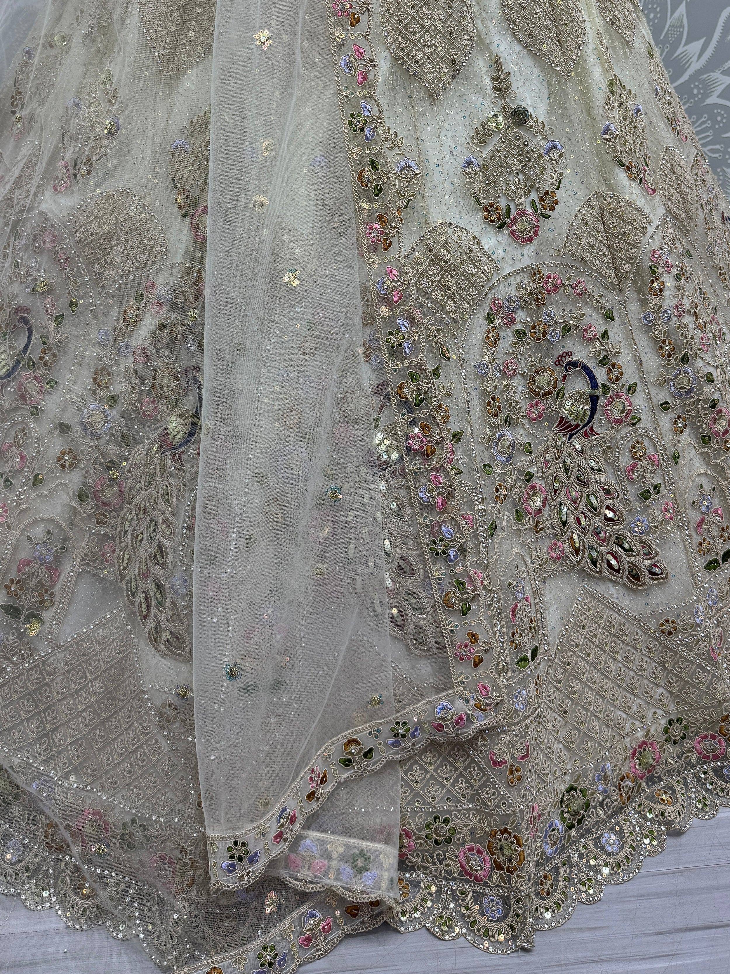 Elegant grey lehenga with intricate floral and peacock embroidery, sequins, and sheer overlay for Indian ethnic wear.