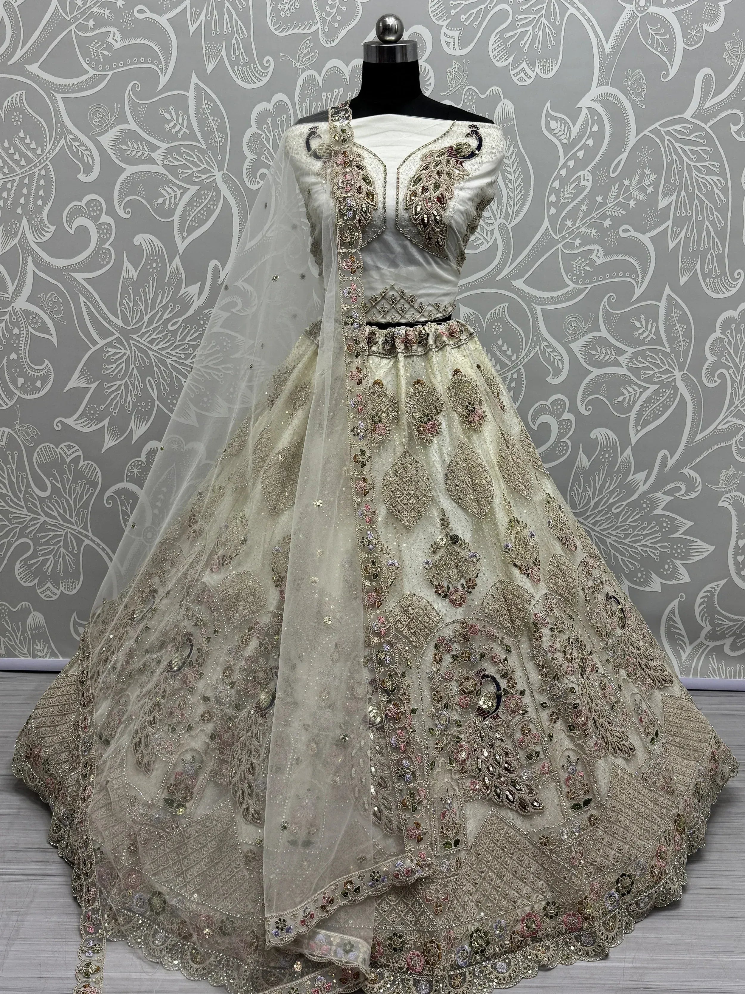 Elegant ivory lehenga choli with peacock embroidery and sequin work, perfect for Indian weddings and festive occasions.