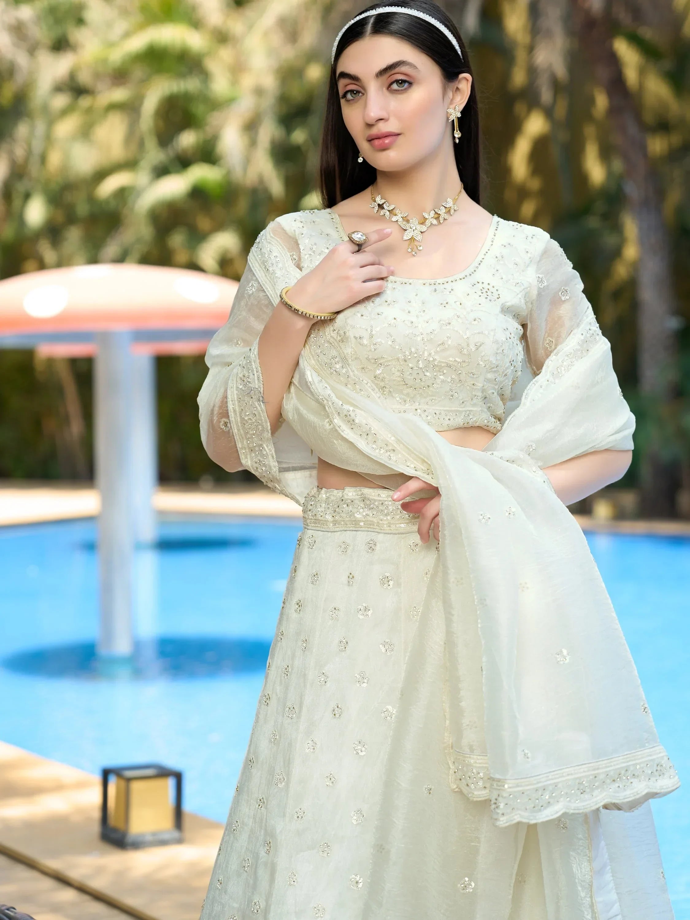 Elegant ivory lehenga choli with intricate embroidery, perfect for Indian ethnic wear occasions.