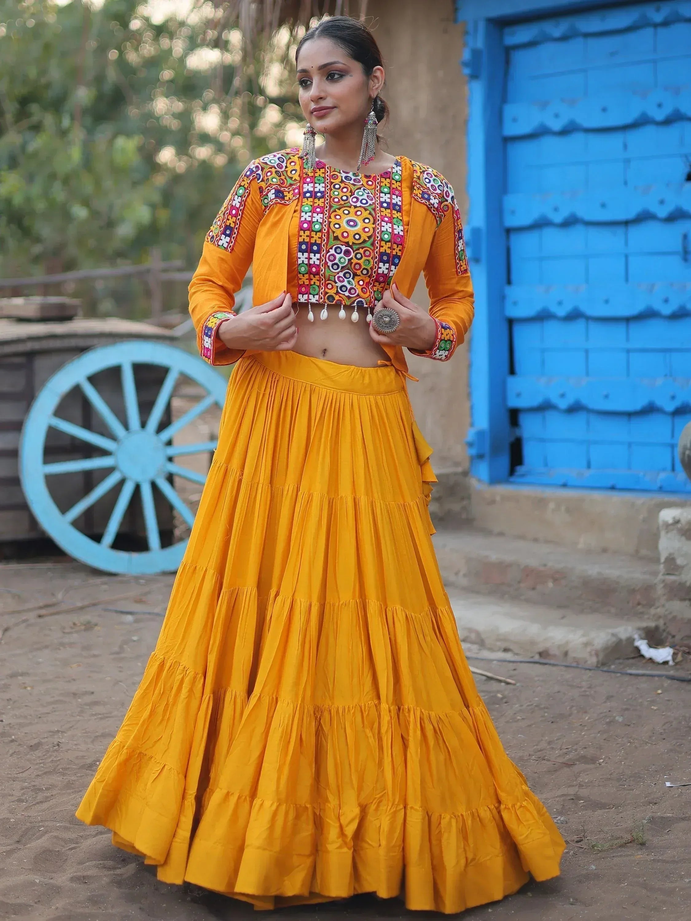 Vibrant yellow ethnic lehenga choli with colorful mirror embroidery, perfect for festive occasions