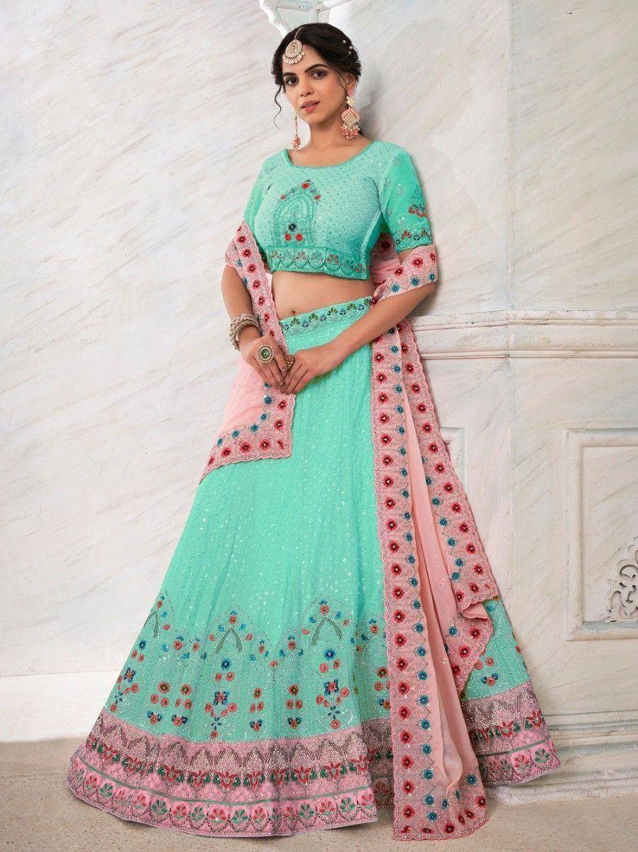 Mint green designer lehenga choli with pink floral embroidery and dupatta, perfect for Indian weddings and festivals.