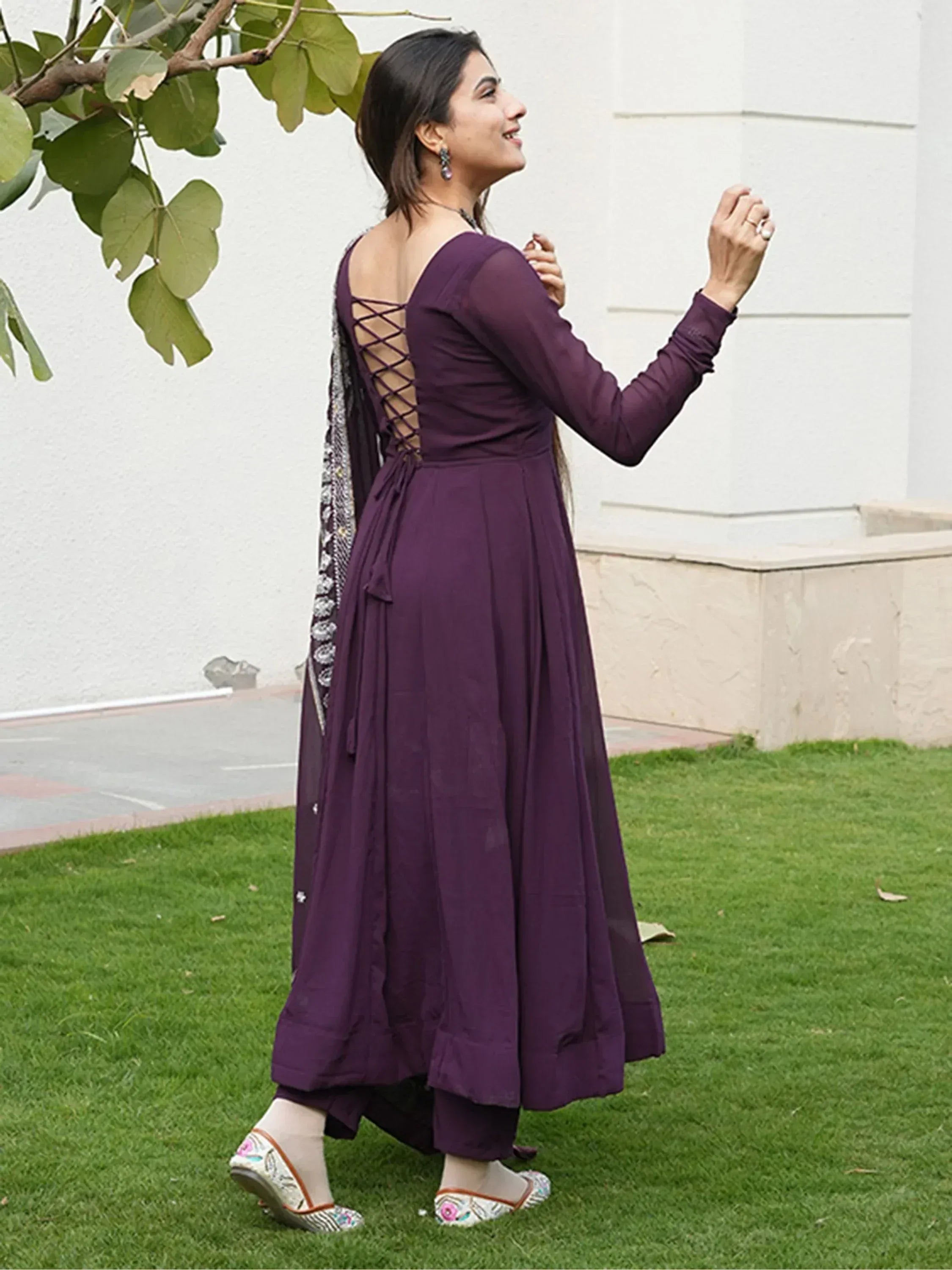Purple ethnic anarkali with lace-up back, paired with embroidered dupatta and flats, perfect for Indian occasions.