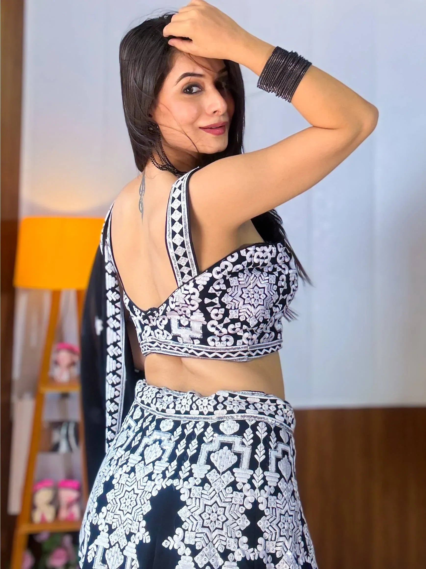 Black and white embroidered lehenga choli with backless blouse, perfect for Indian ethnic wear occasions.