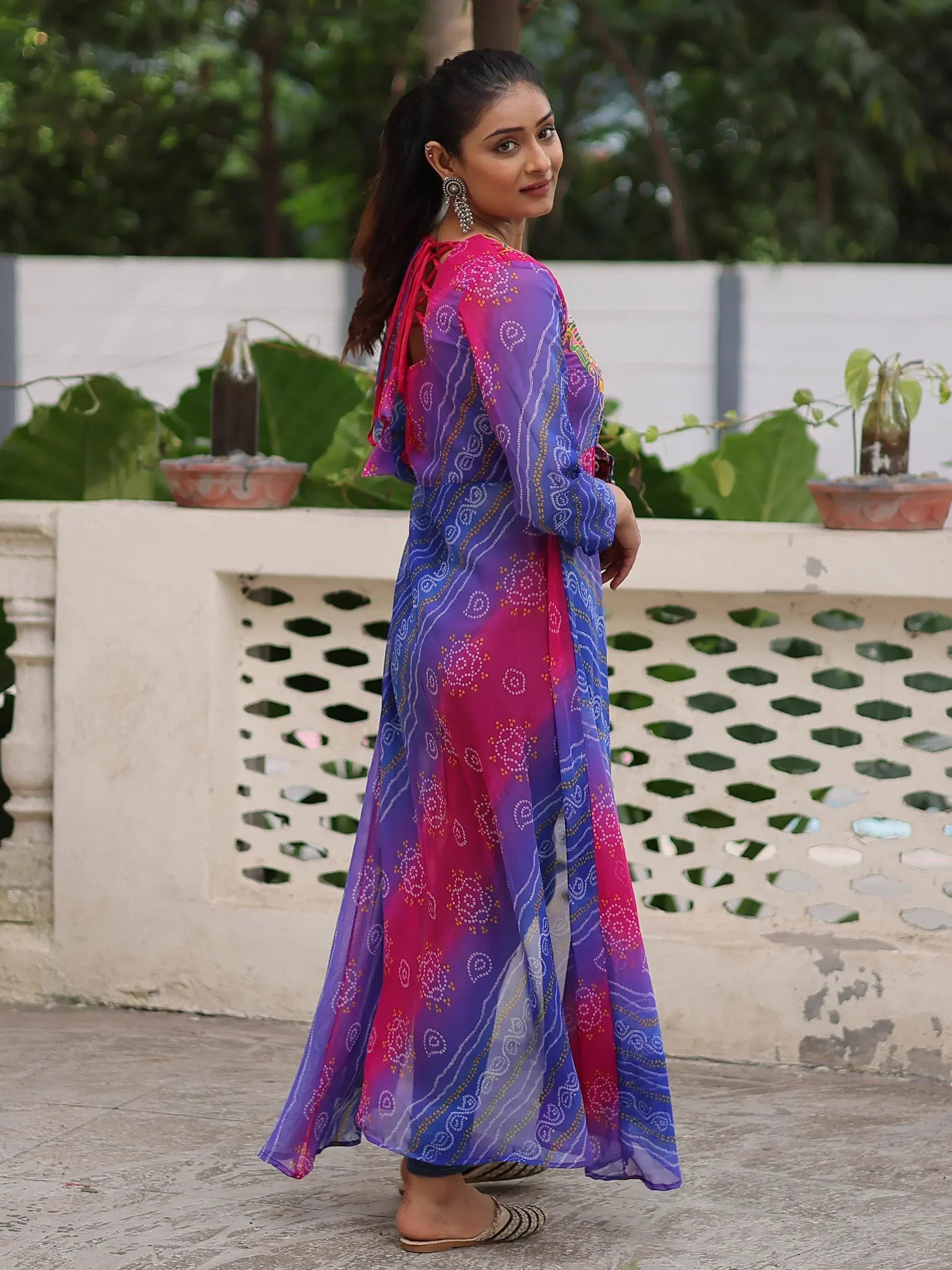 Woman in colorful Indian ethnic gown with pink purple blue ombre and mirror work, perfect for festive occasions