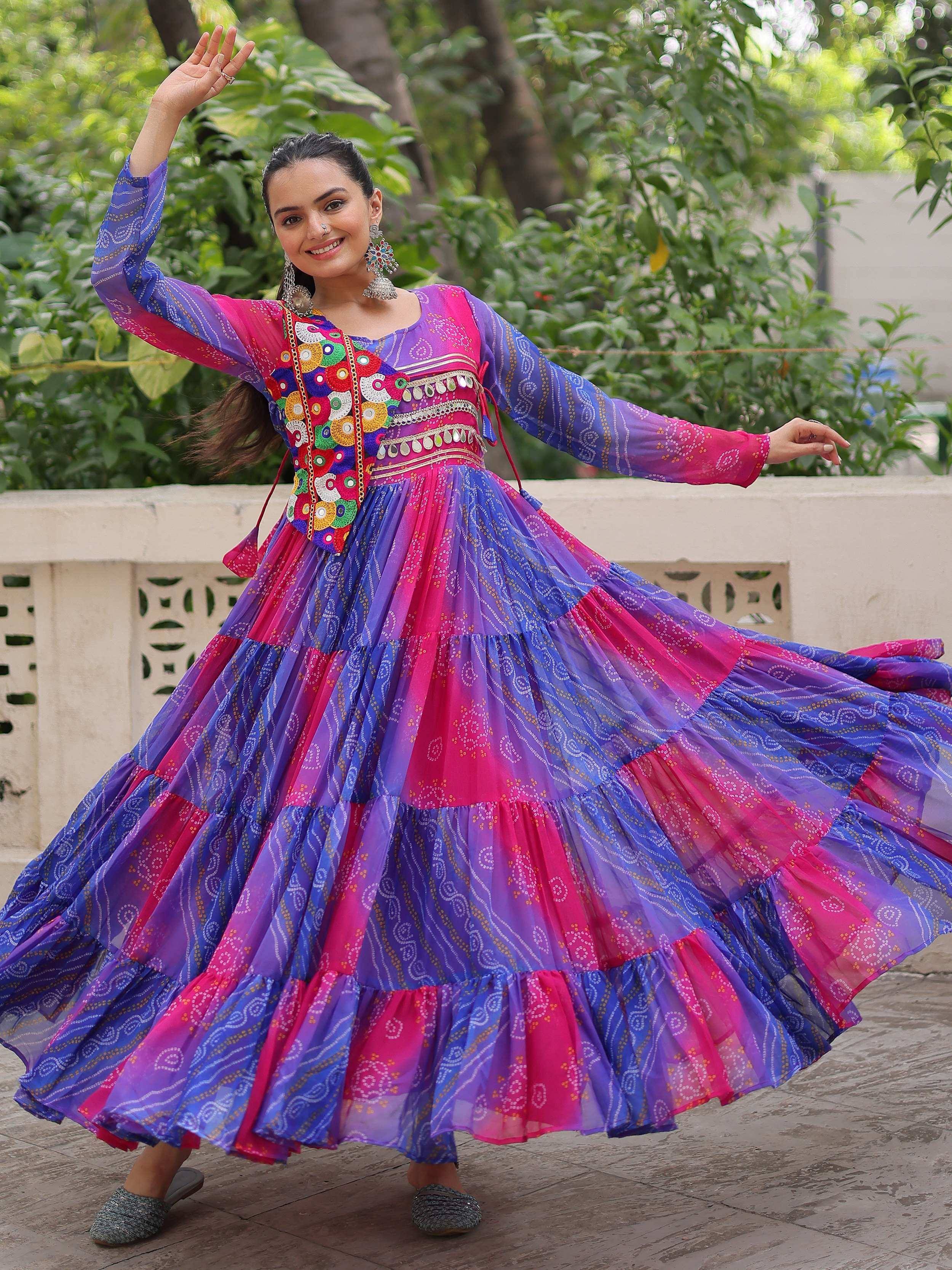 Vibrant pink and blue ethnic gown with colorful embroidery, perfect for festive occasions.
