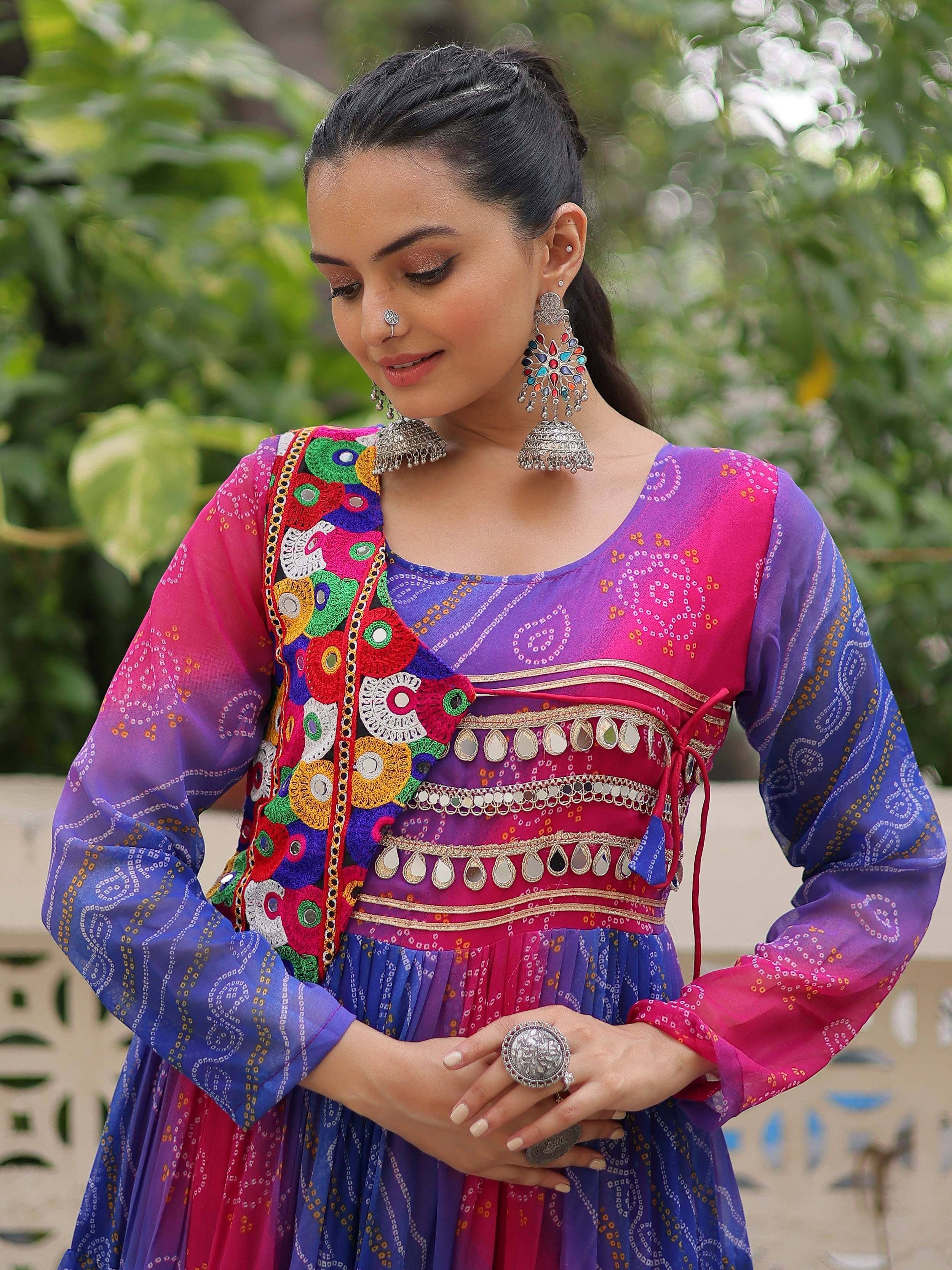 Vibrant Indian ethnic gown with mirror work and colorful embroidery, perfect for festive occasions.