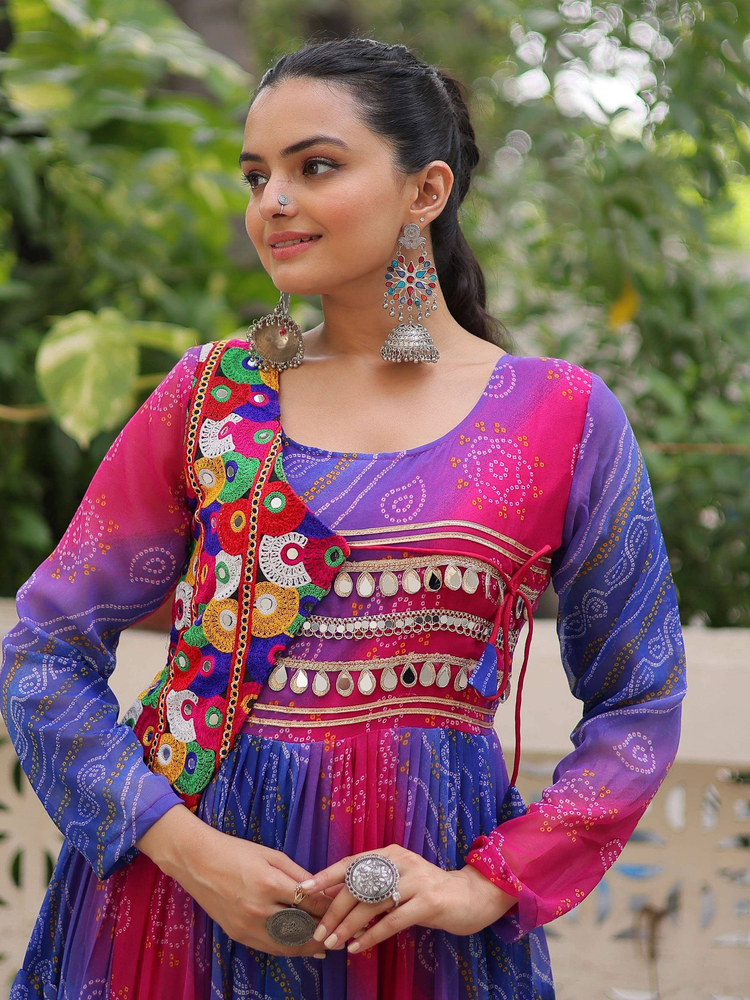 Woman in colorful Indian ethnic gown with mirror work, embroidery, and traditional jewelry