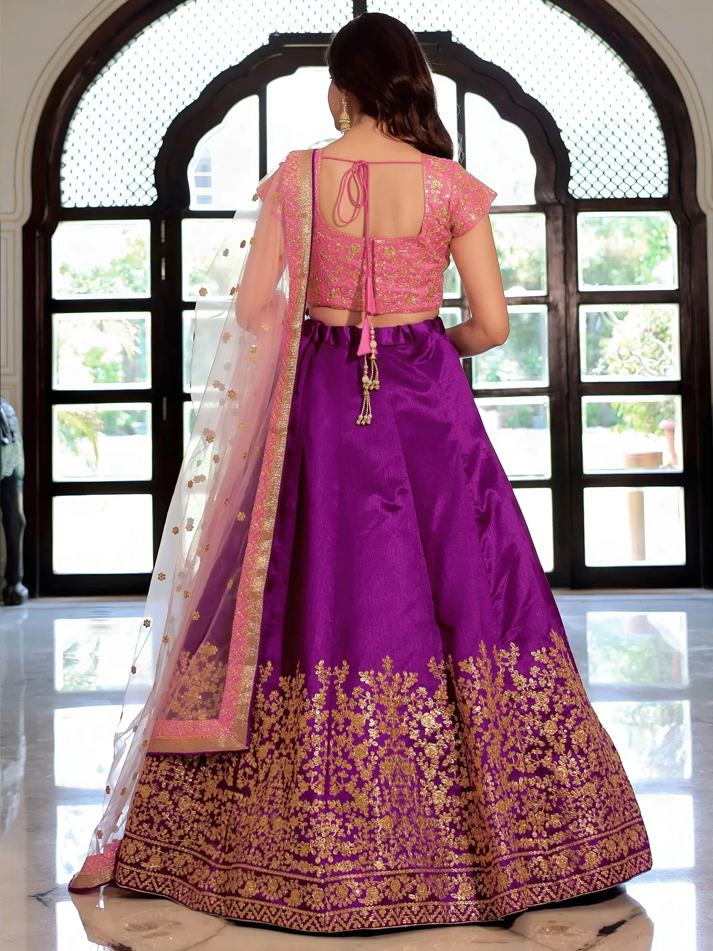 Purple and pink designer lehenga choli with gold embroidery, back view, ethnic wear