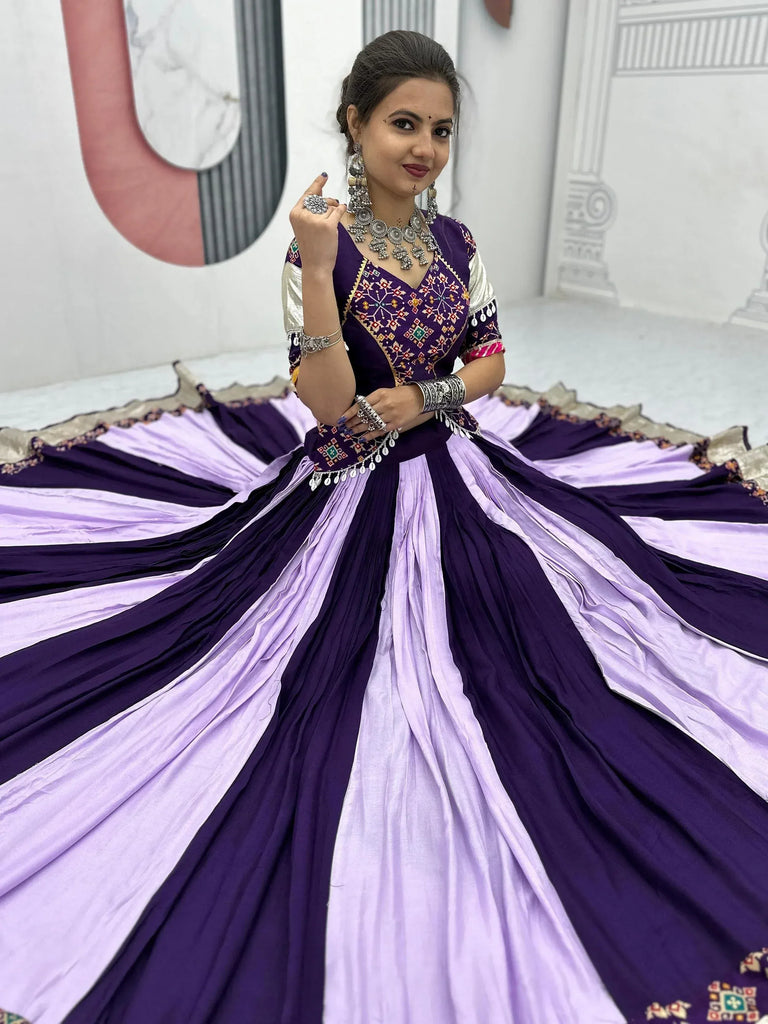 Woman in purple and lavender ethnic gown with embroidery and silver jewelry