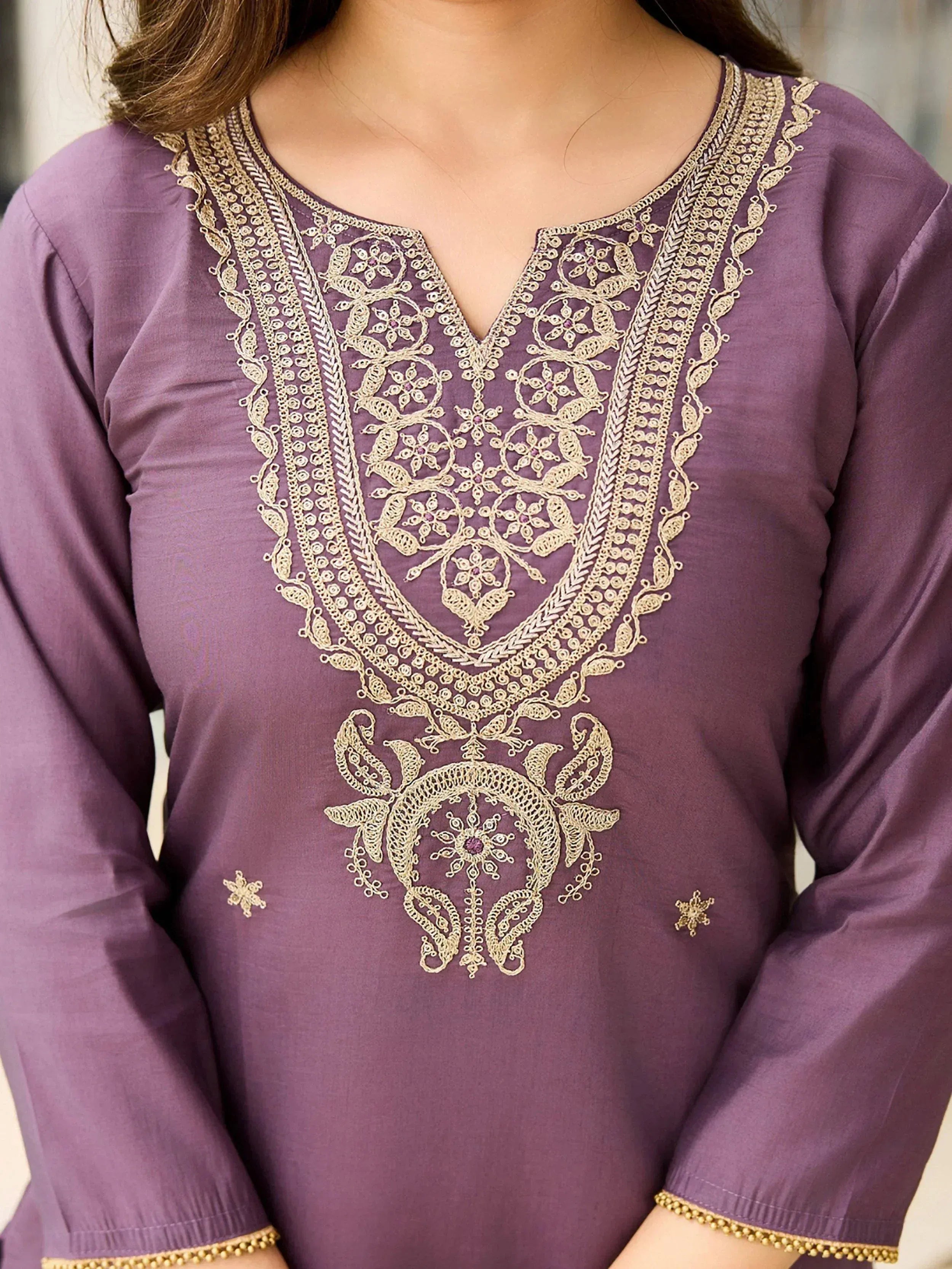 Purple ethnic kurti with intricate gold embroidery and floral designs