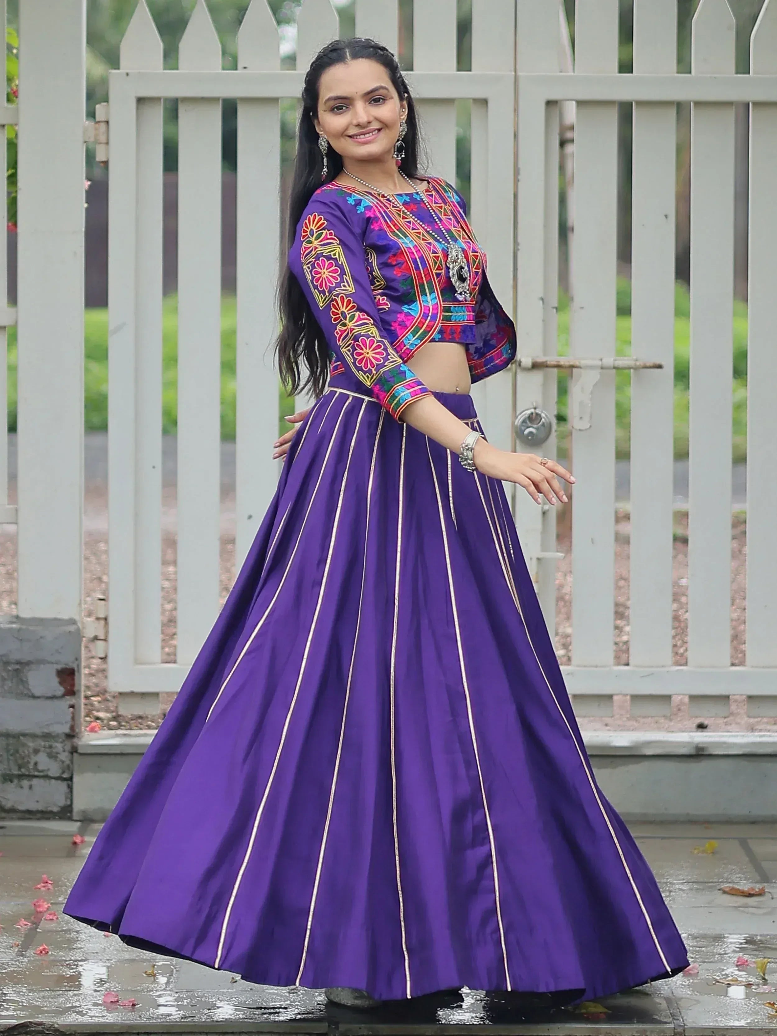 Purple embroidered lehenga choli with floral top and gold stripes, perfect for Indian ethnic wear