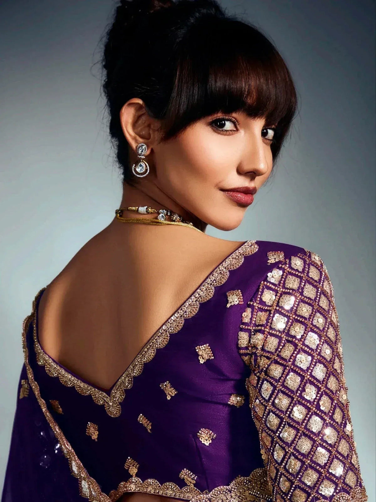 Purple designer saree with gold sequin embroidery and elegant backless blouse