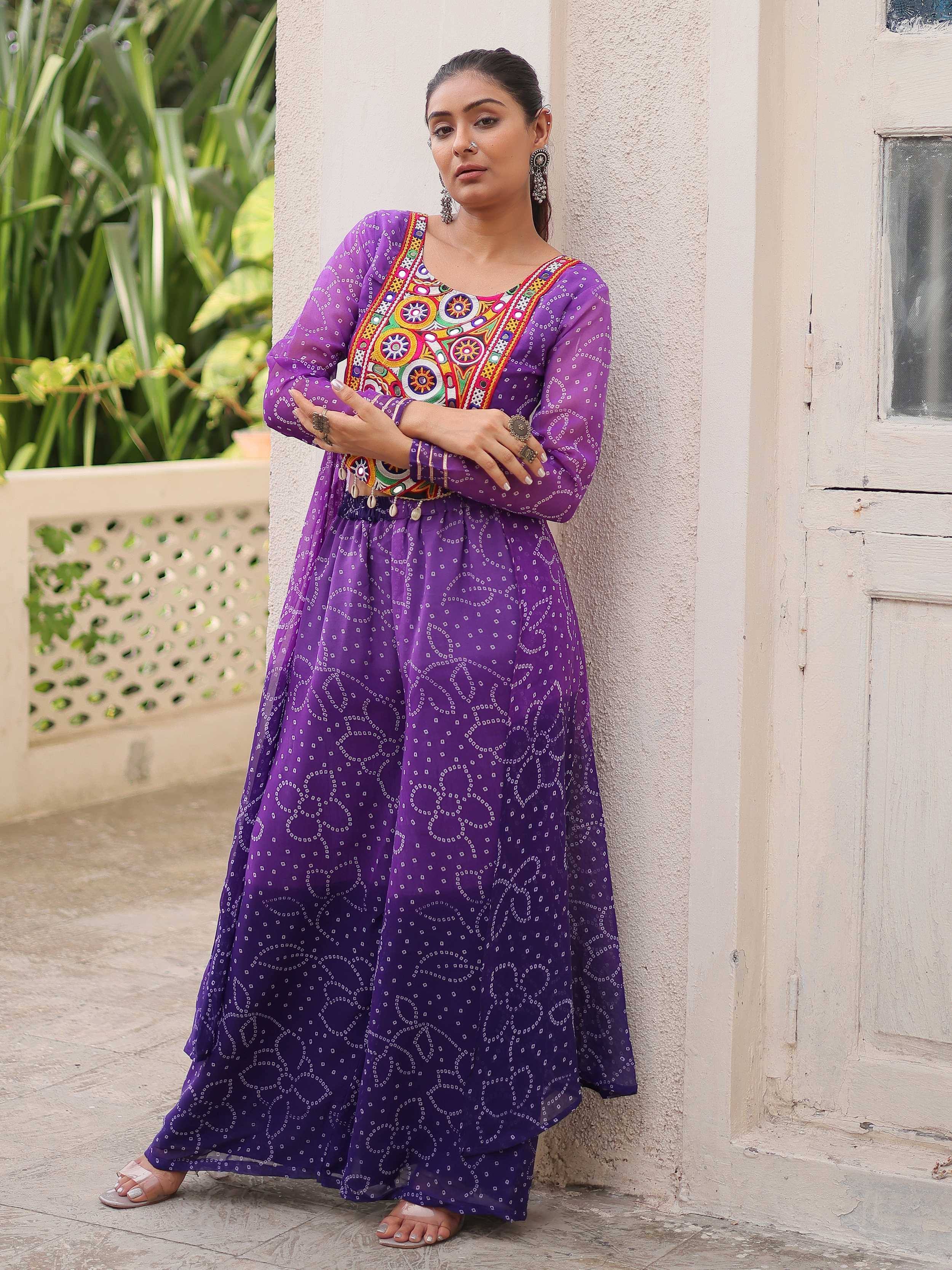 Purple ethnic gown with colorful embroidery and floral patterns, perfect for Indian festive occasions.