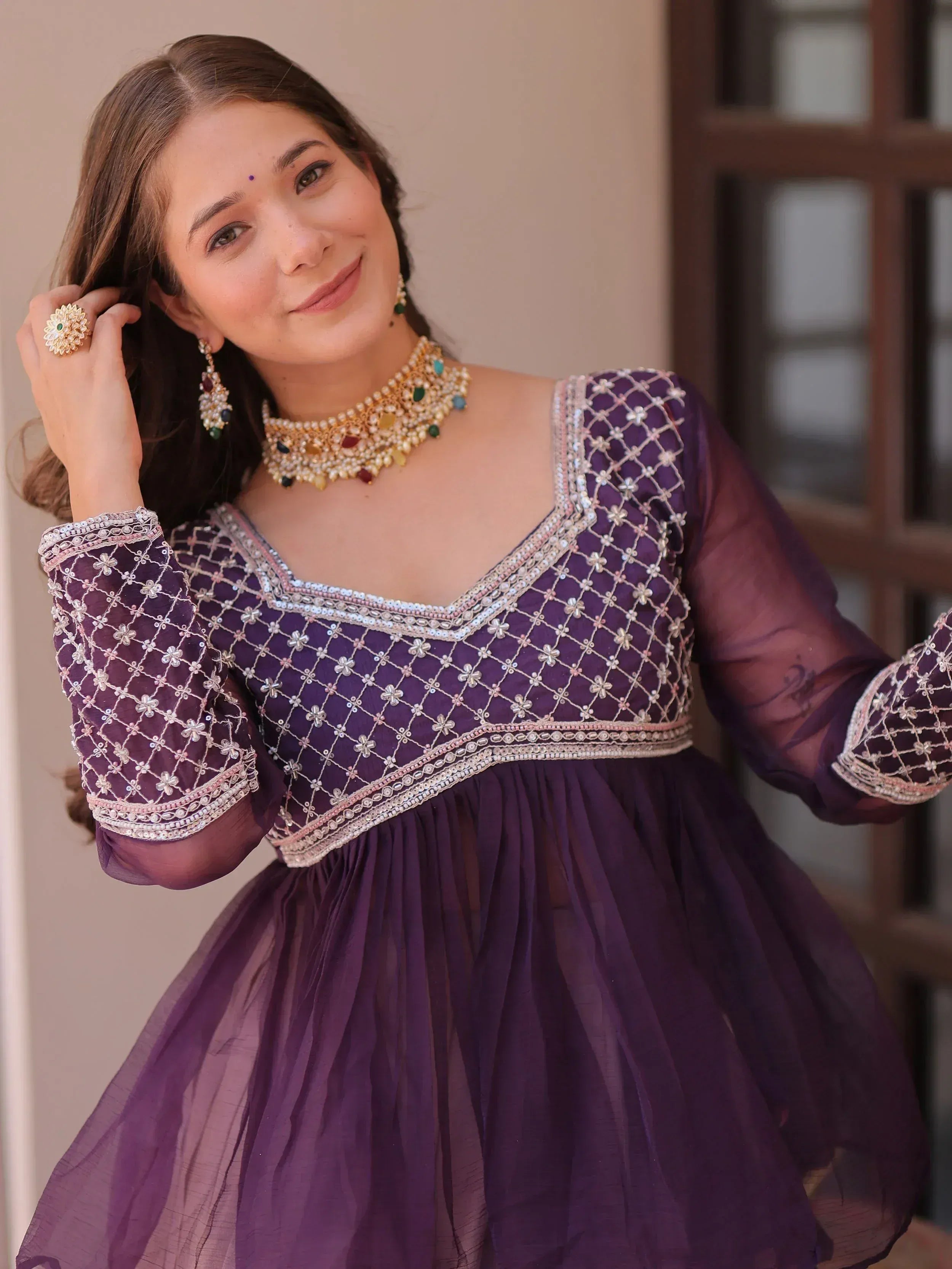 Purple embroidered ethnic gown with sheer sleeves and traditional jewelry