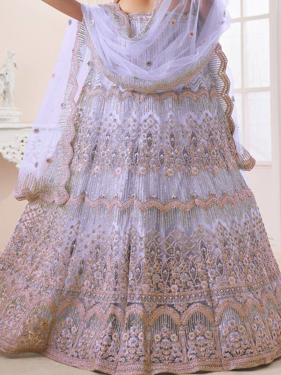 Elegant lavender lehenga choli with gold embroidery and sheer dupatta, perfect for Indian ethnic occasions