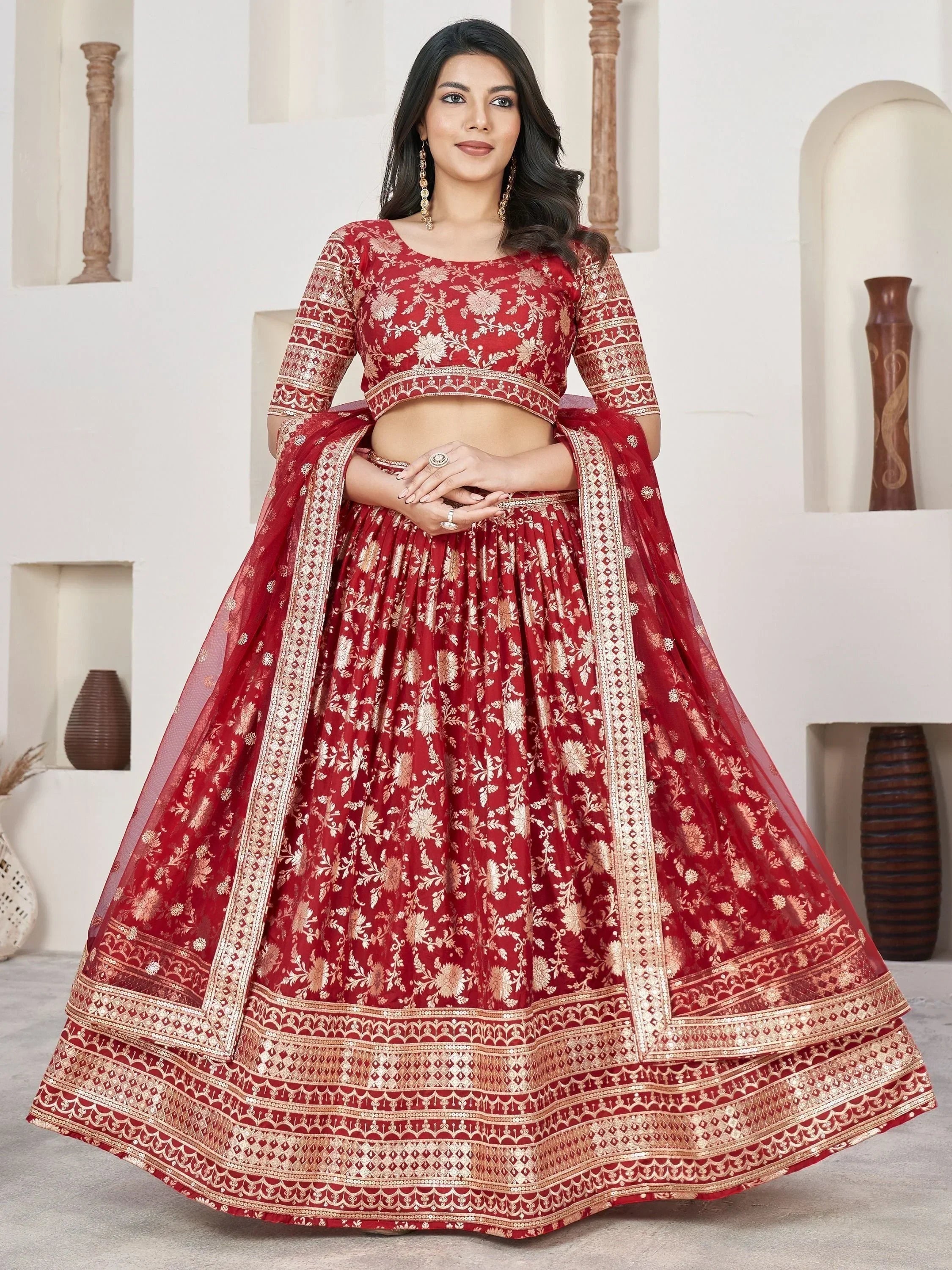 Red floral embroidered lehenga choli with gold detailing, perfect for Indian weddings and festive occasions.