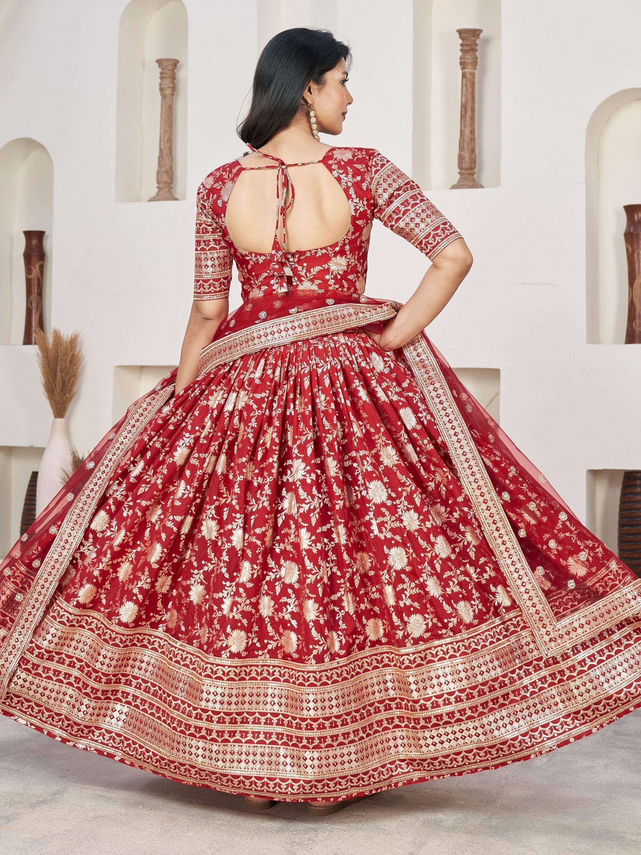 Red floral embroidered lehenga choli with open back, perfect for Indian weddings and festive occasions