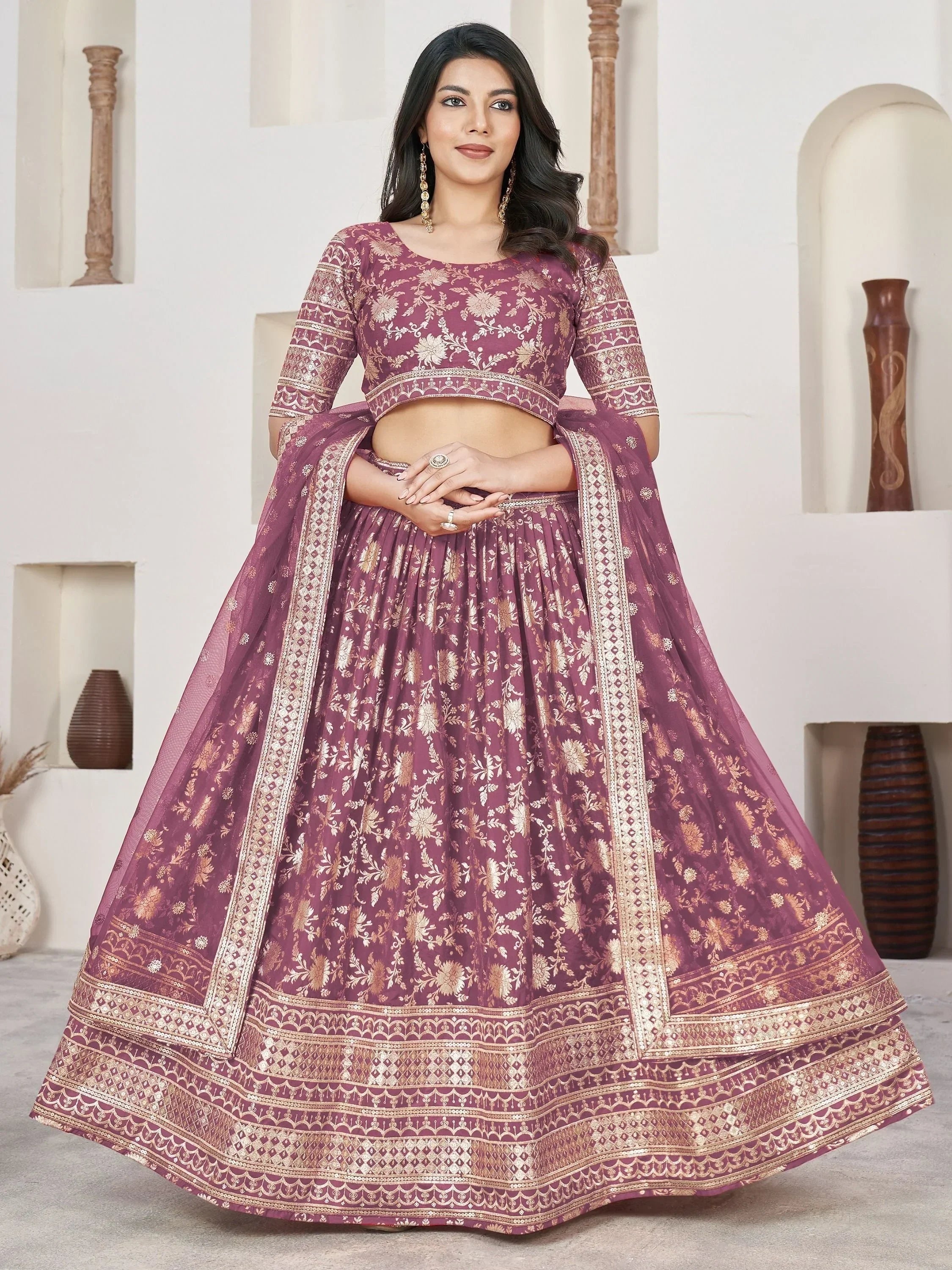 Elegant maroon lehenga choli with gold floral embroidery, perfect for Indian ethnic wear occasions.