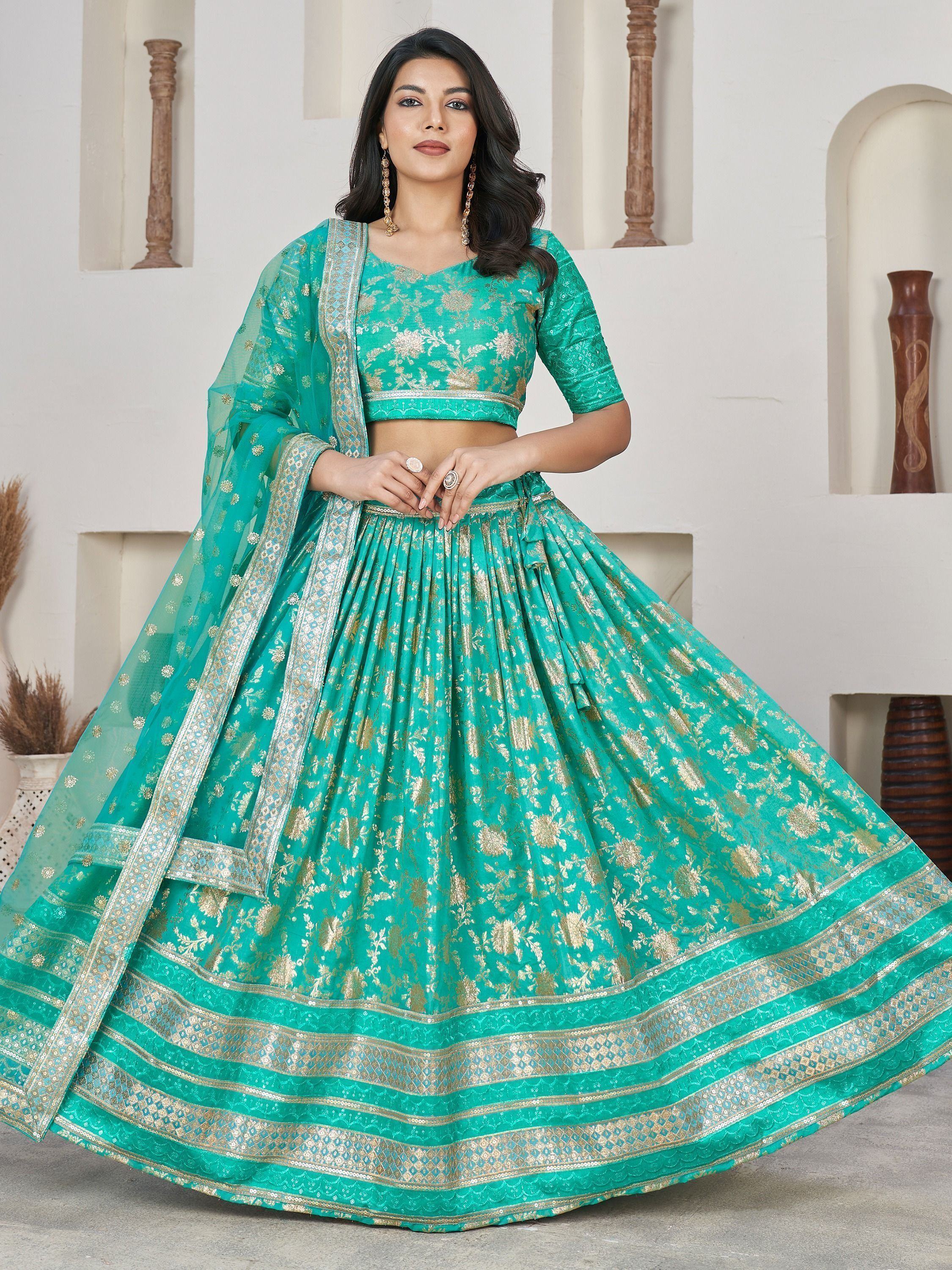Teal green designer lehenga choli with gold floral embroidery and dupatta, perfect for Indian ethnic occasions
