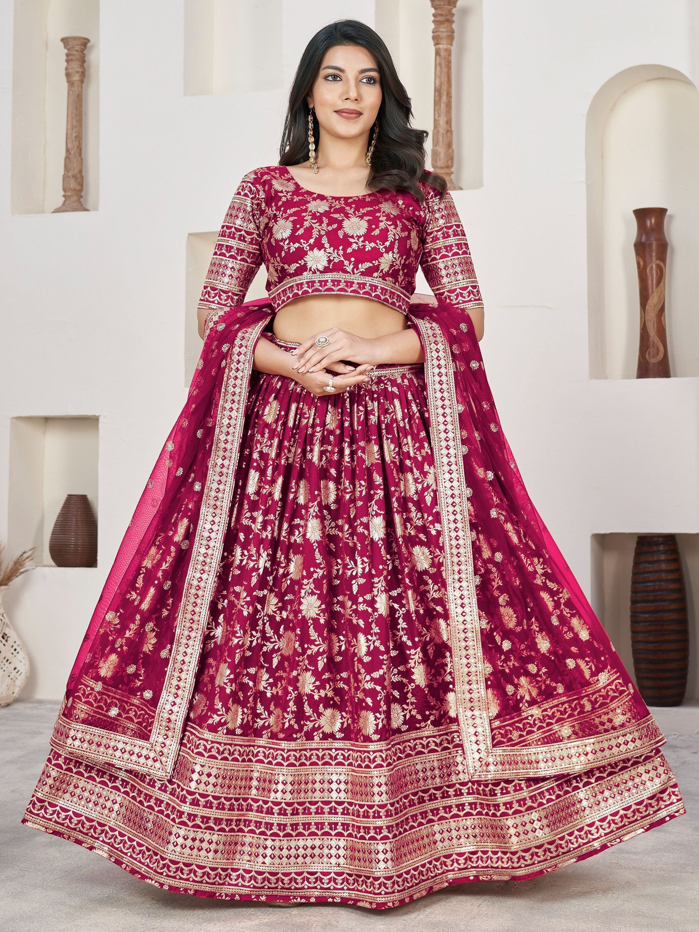 Maroon designer lehenga choli with gold floral embroidery and embellished borders, perfect for Indian weddings and festive occasions.