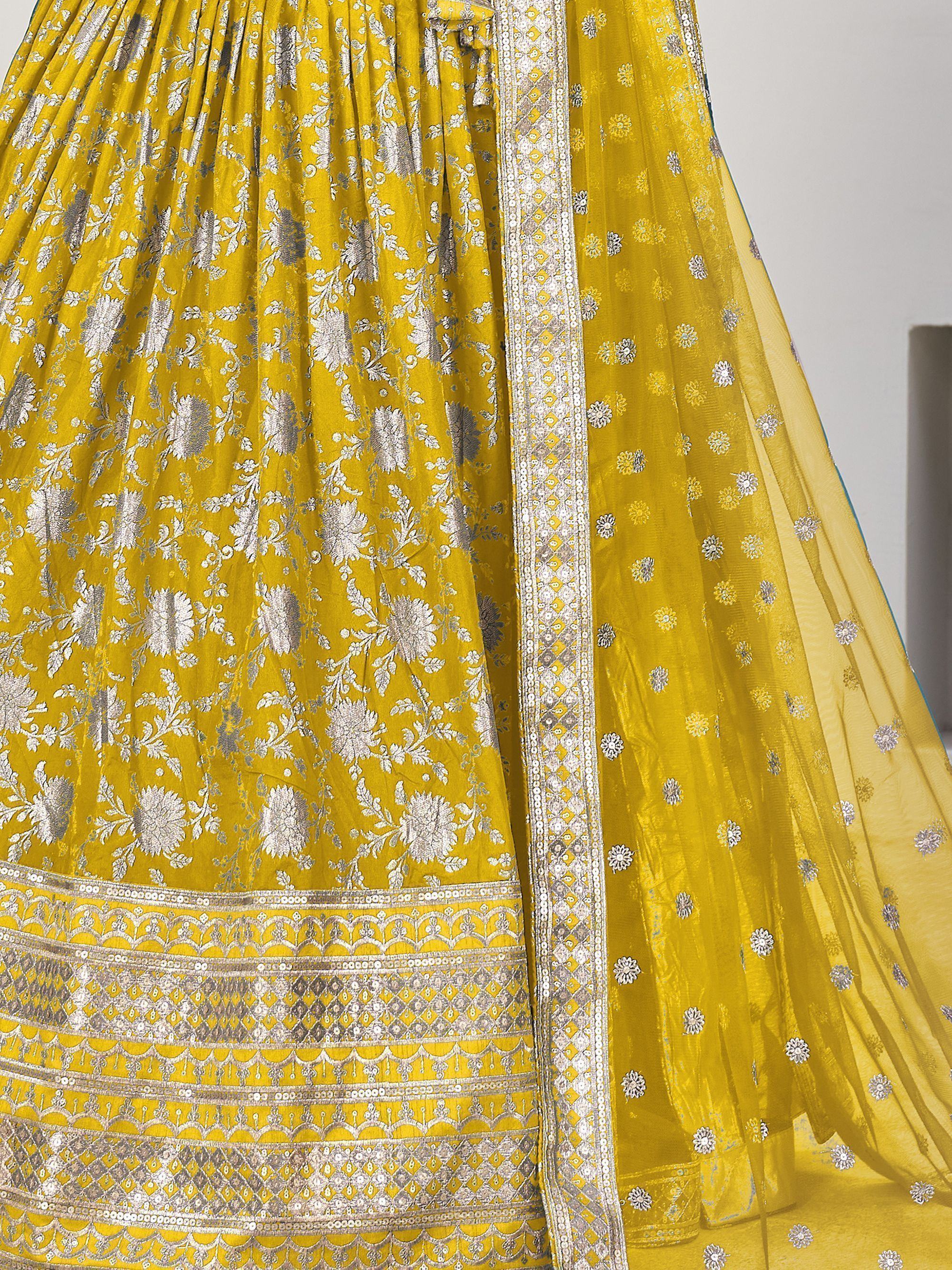 Yellow designer lehenga choli with silver floral embroidery and embellished border, ethnic Indian wear