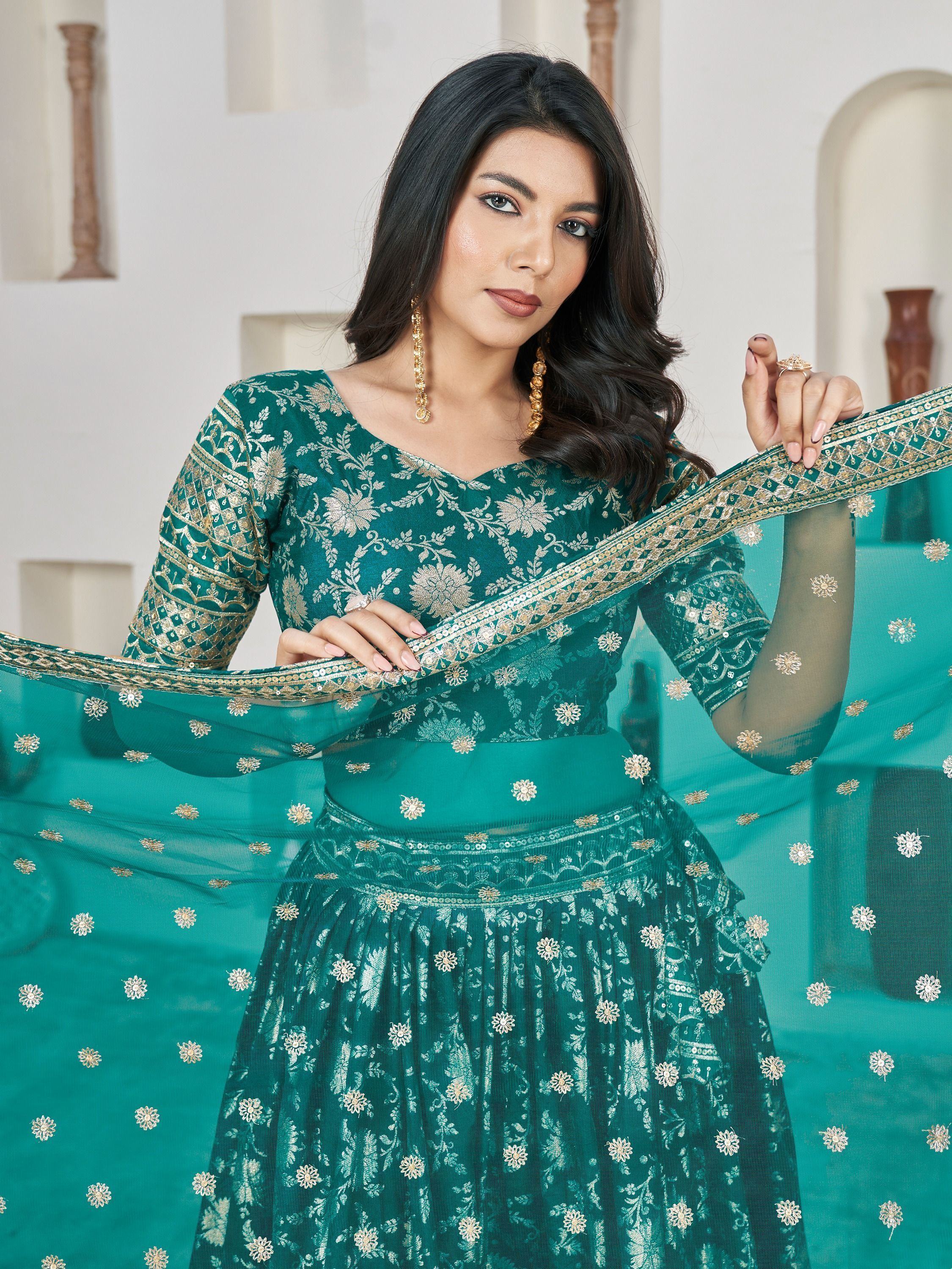 Emerald green designer lehenga choli with gold floral embroidery and sheer dupatta for Indian ethnic wear